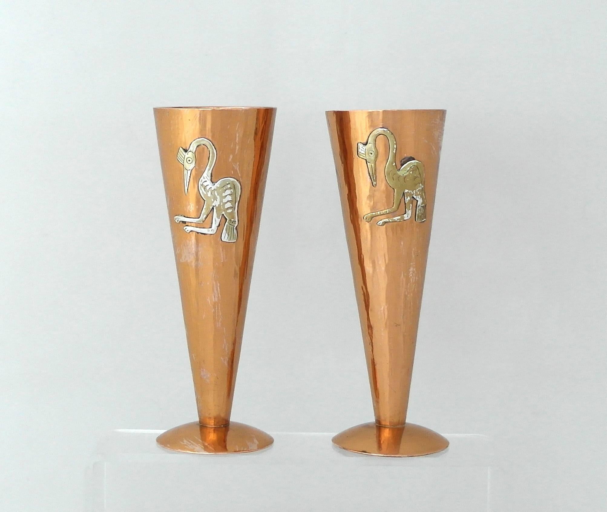 Being offered are a charming pair of circa 1975 copper and sterling silver vases by Vicky of Peru. Handmade and hammered pair with applied sterling silver exotic birds on opposite ends of each vase. Dimensions: 6 1/2 inches high x 2 1/4 inches
