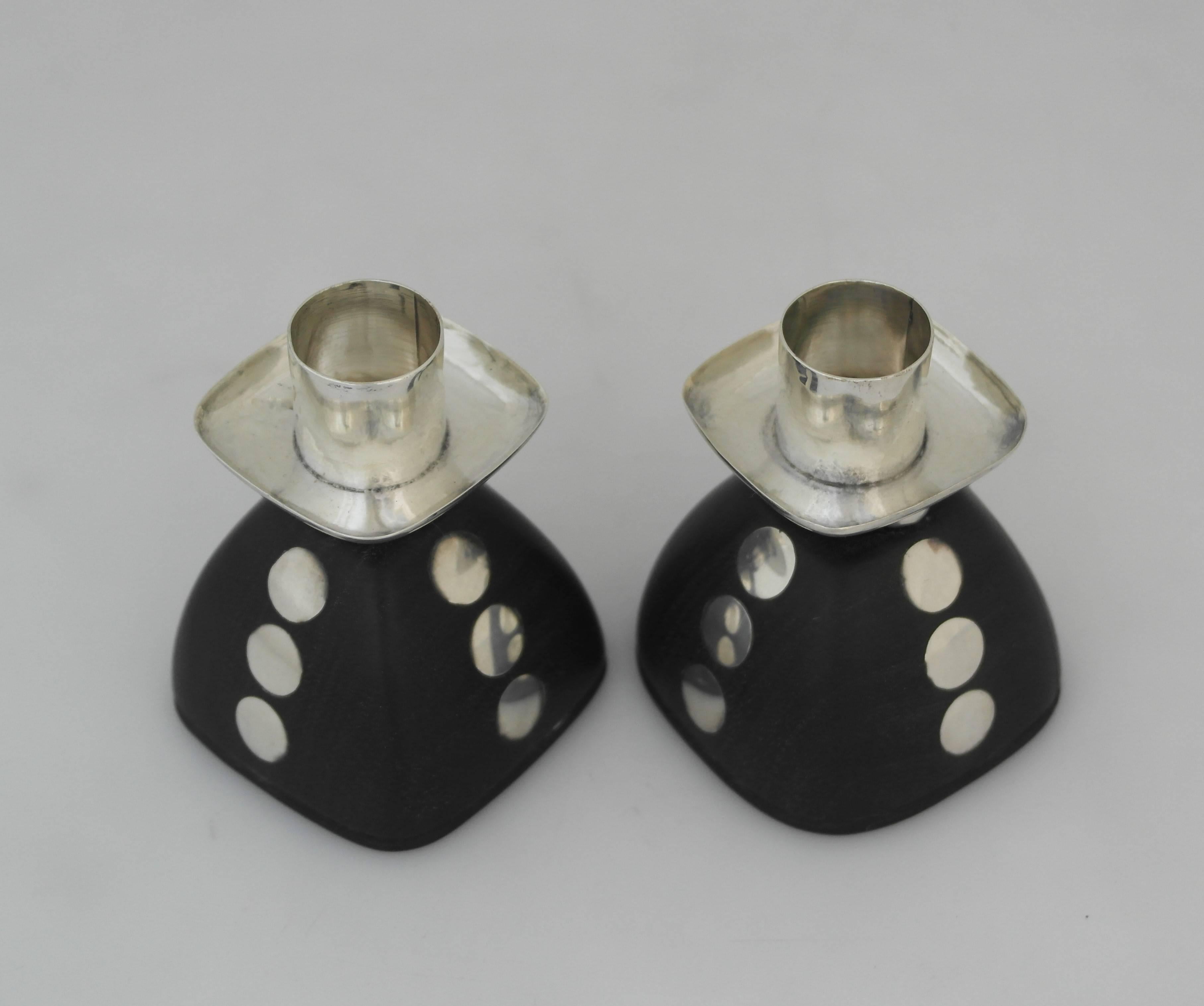 Being offered are a pair of sterling silver candlesticks by William Spratling of Taxco, Mexico. Bell shaped pair carved out of rosewood with applied silver discs; silver bobeches resting on ball motifs. Dimensions: 3 1/2 inches height x 2 3/4 inches