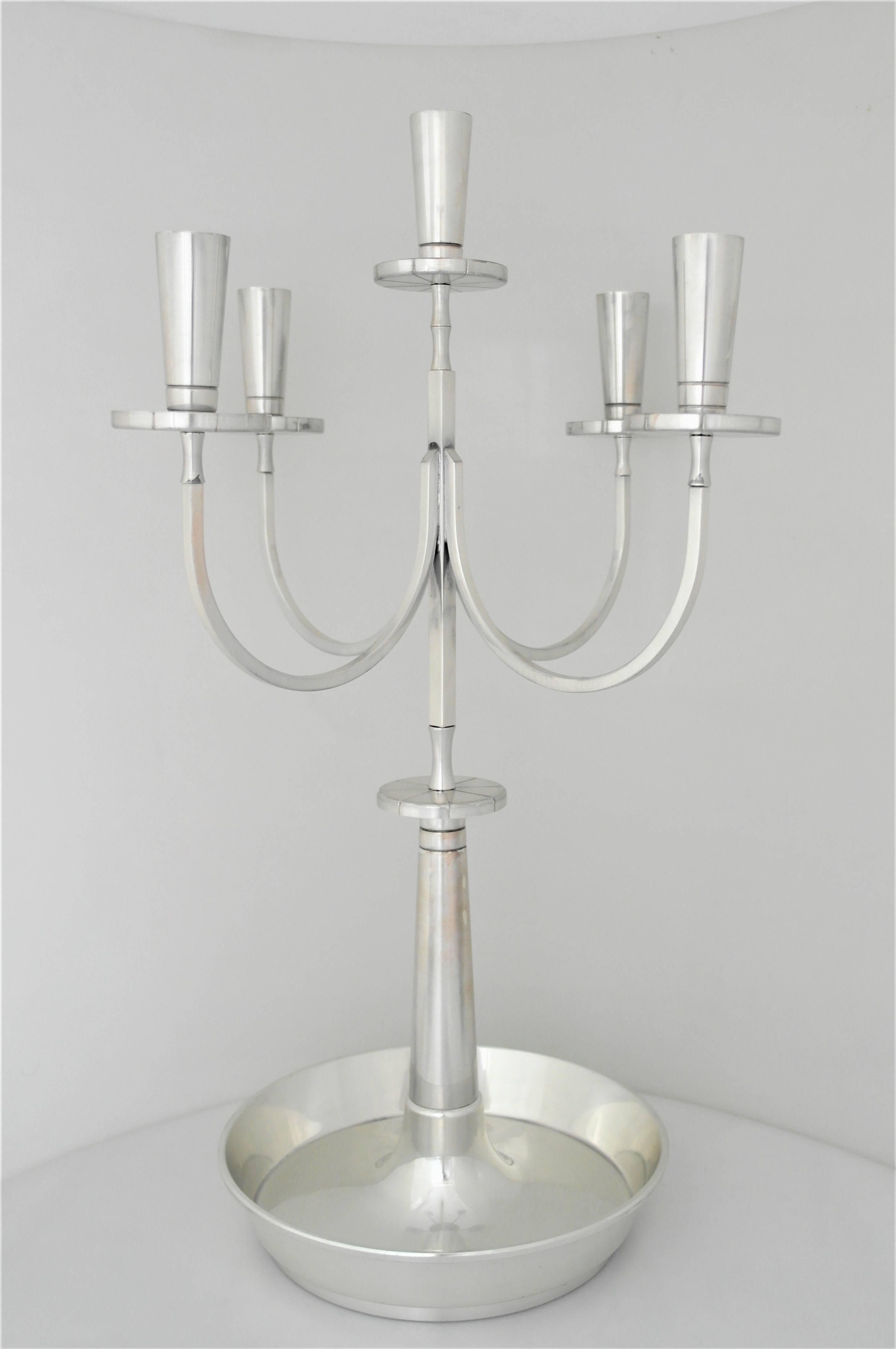 Tommi Parzinger (1903-1981) design modernist silver plate pair of candelabra, being offered; Dorlyn Silversmiths; 1950s.  Silver-plated brass; impressed manufacturer's mark to both (PR 70); 5 light with super extended arms; 13" diameter by