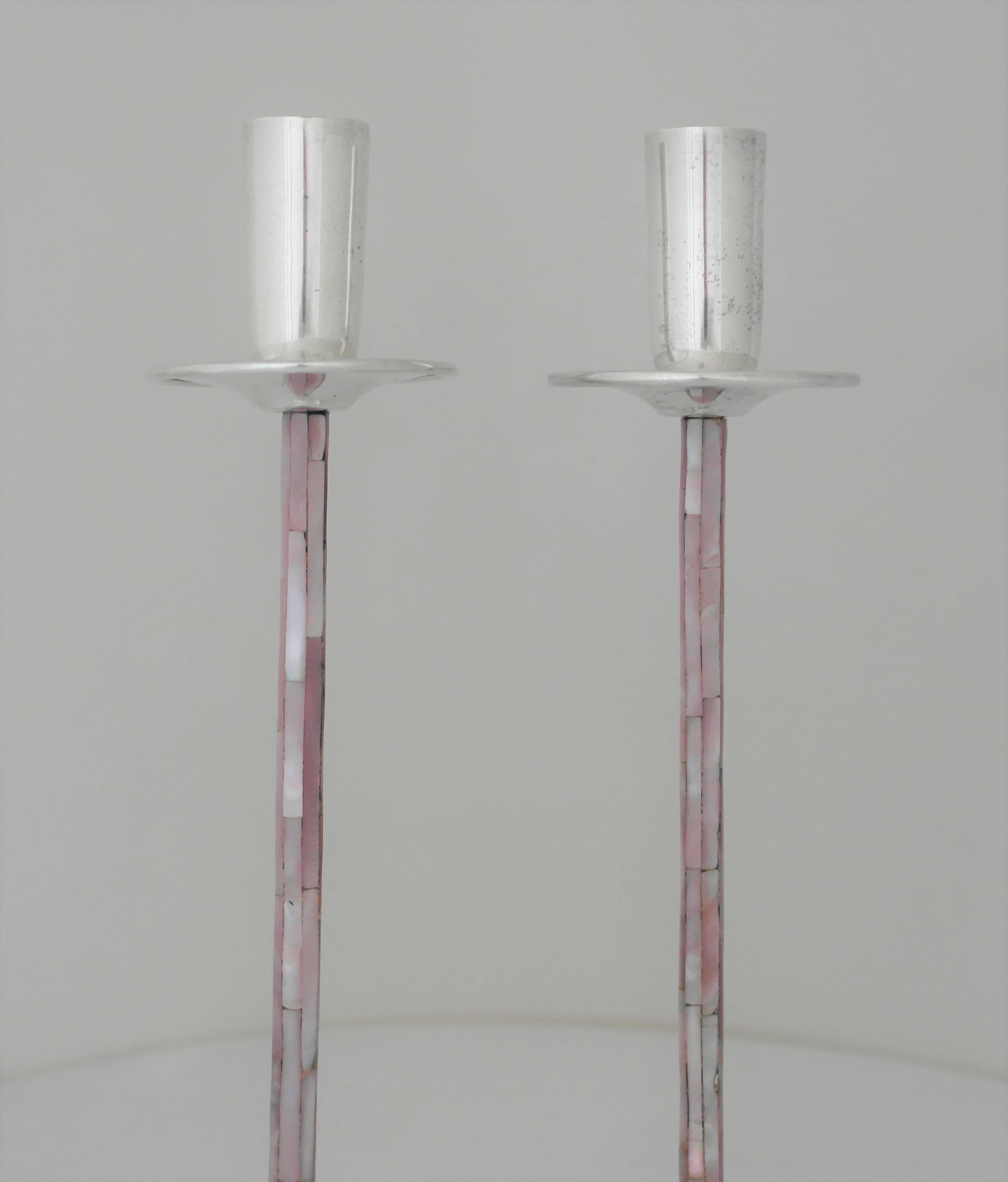 Being offered is a pair of highly decorative candlesticks by Los Castillo of Taxco, Mexico. Hand-wrought pair made of silver plate with abalone inlay on the tall, elegant stems. Dimensions: 11 1/2 inches tall; 3 inches diameter. Marked as