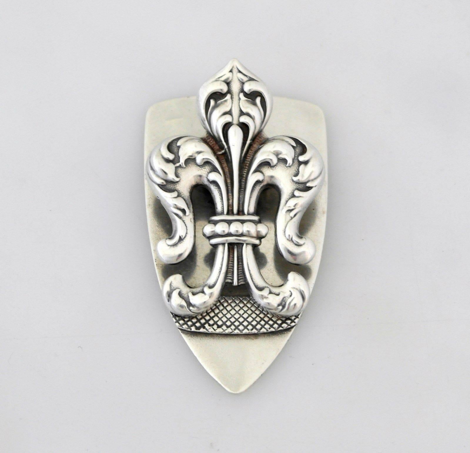 Being offered is a fine sterling silver document clip by George Shiebler, of New York; crest shaped with attached fleur-des-lis clip; superb detail. Dimensions: 2 7/8
