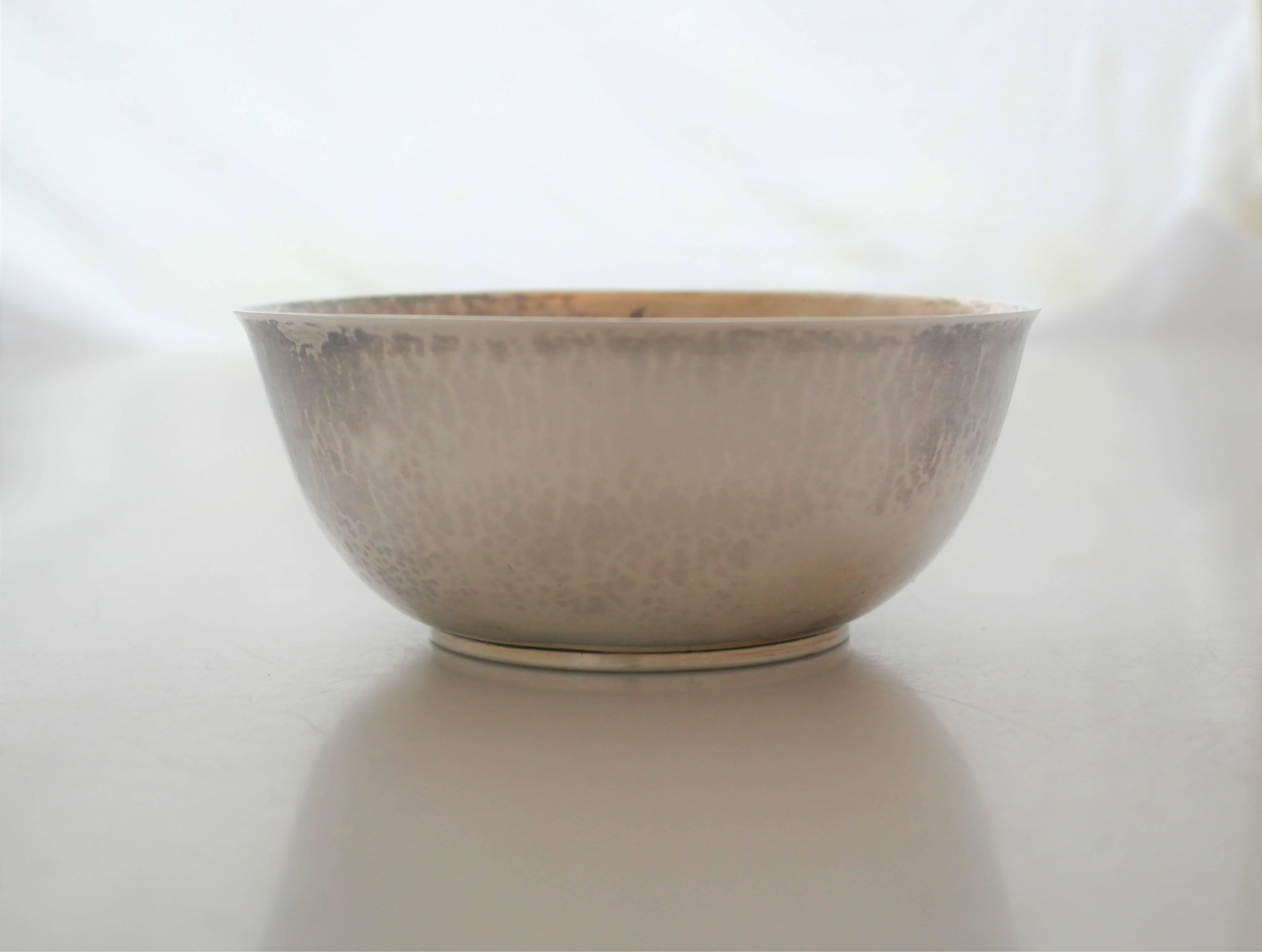 Being offered is a hand-wrought Arts & Crafts period sterling silver bowl made by Frederick Gyllenberg at the handicraft shop in Boston, Massachusetts. Hand raised bowl with all-over spot hammering; on a circular pedestal base. Dimensions: 5 1/2