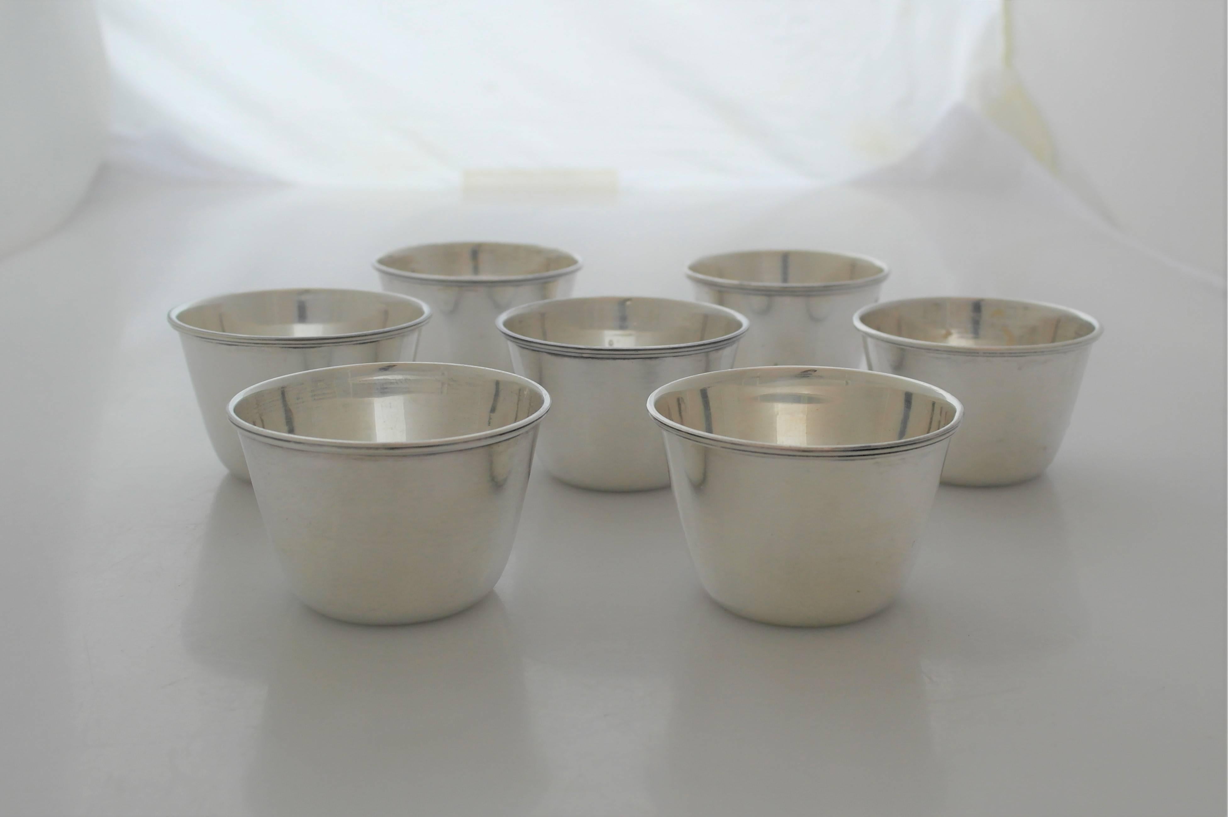 Being offered are a set of seven sterling silver cups made by Tane of Mexico City. Heavy gauge cups in the modernist taste. Perfect for various types of beverages. Dimensions: 1 3/4 inches height by 2 1/2 inches diameter. Combined weight is over 10