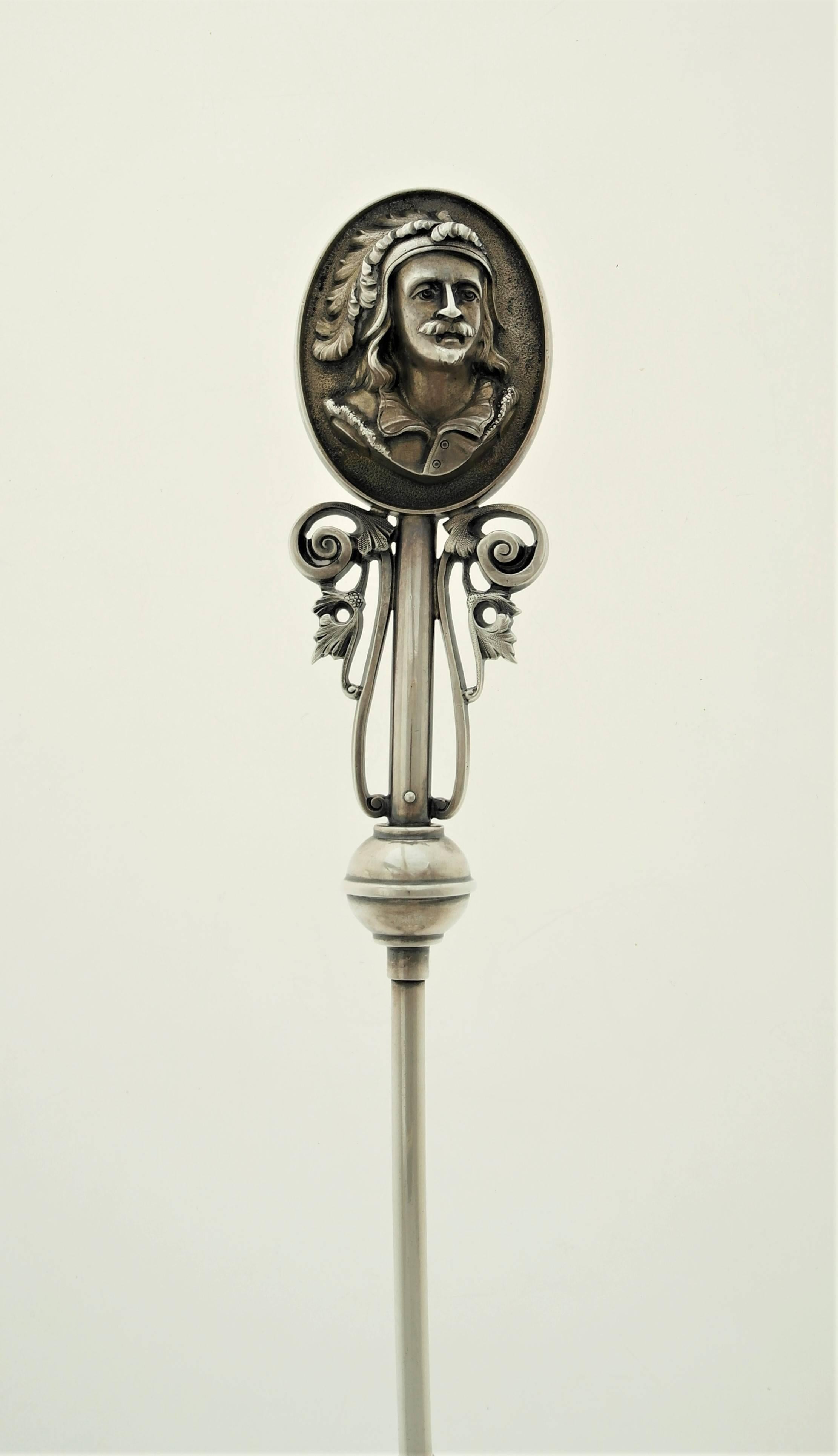 A circa 1860 coin silver soup ladle made by Wood & Hughes of New York. In the medallion pattern with bust of a soldier in high relief; round stem and trefoil fluted bowl. Measures: Length 15 inches; bowl 5 inches wide by 4 inches deep. In excellent
