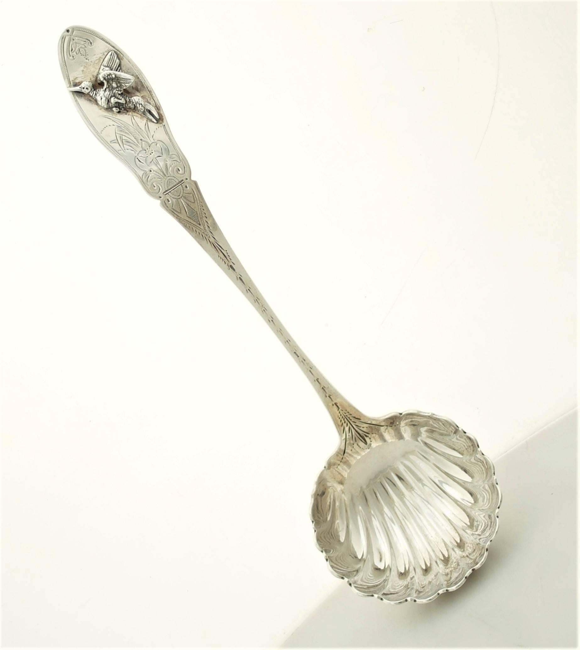 A circa 1855 coin silver ladle made by Peter Krider of Philadelphia, Pennsylvania. Ladle with shaped terminal with applied bird, engraved and bright cut handle continuing to fluted bowl. Dimensions 9 1/4 inches long; bowl is 2 3/4 inches wide by 2