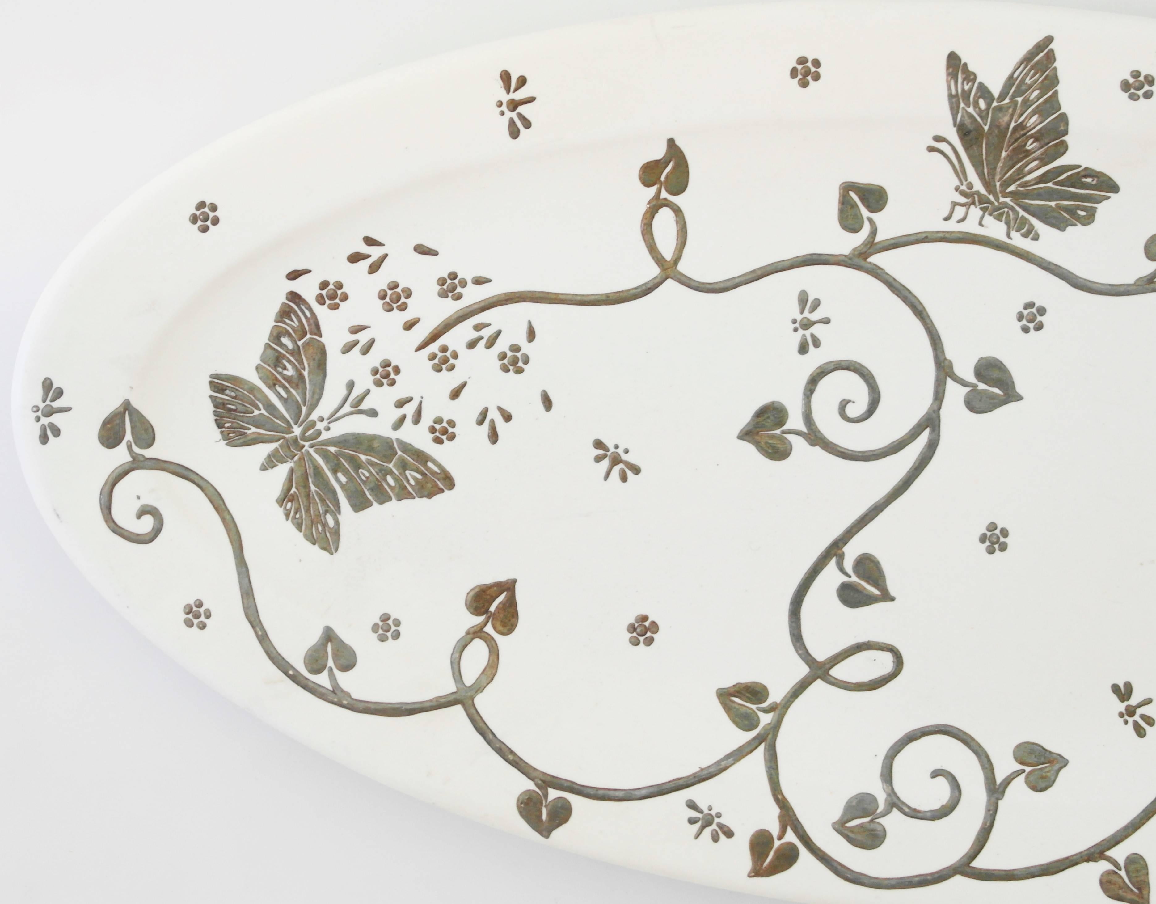 Being offered is a serving plate by Emilia Castillo of Taxco, Mexico. Oval ceramic plate decorated with sterling silver overlay, including butterflies, dragonflies & foliate. Dimensions: 15