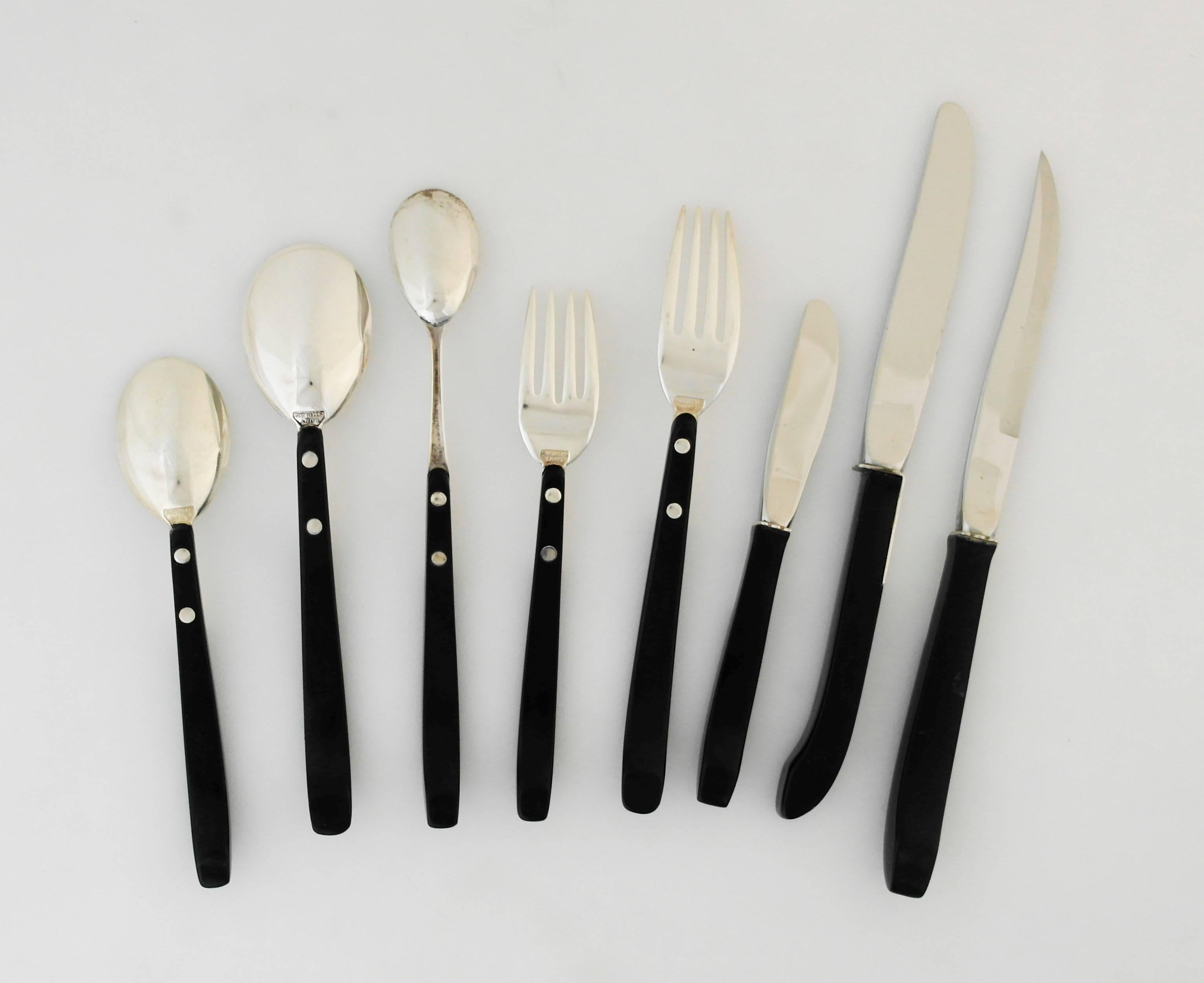 Being offered is a fine, circa 1956 sterling silver flatware set designed by Nord Bowlen for Lunt, of Greenfield, MA, using black nylon handles as a glorious counterpoint to sterling silver and emphasizing the combination of silver and plastics in