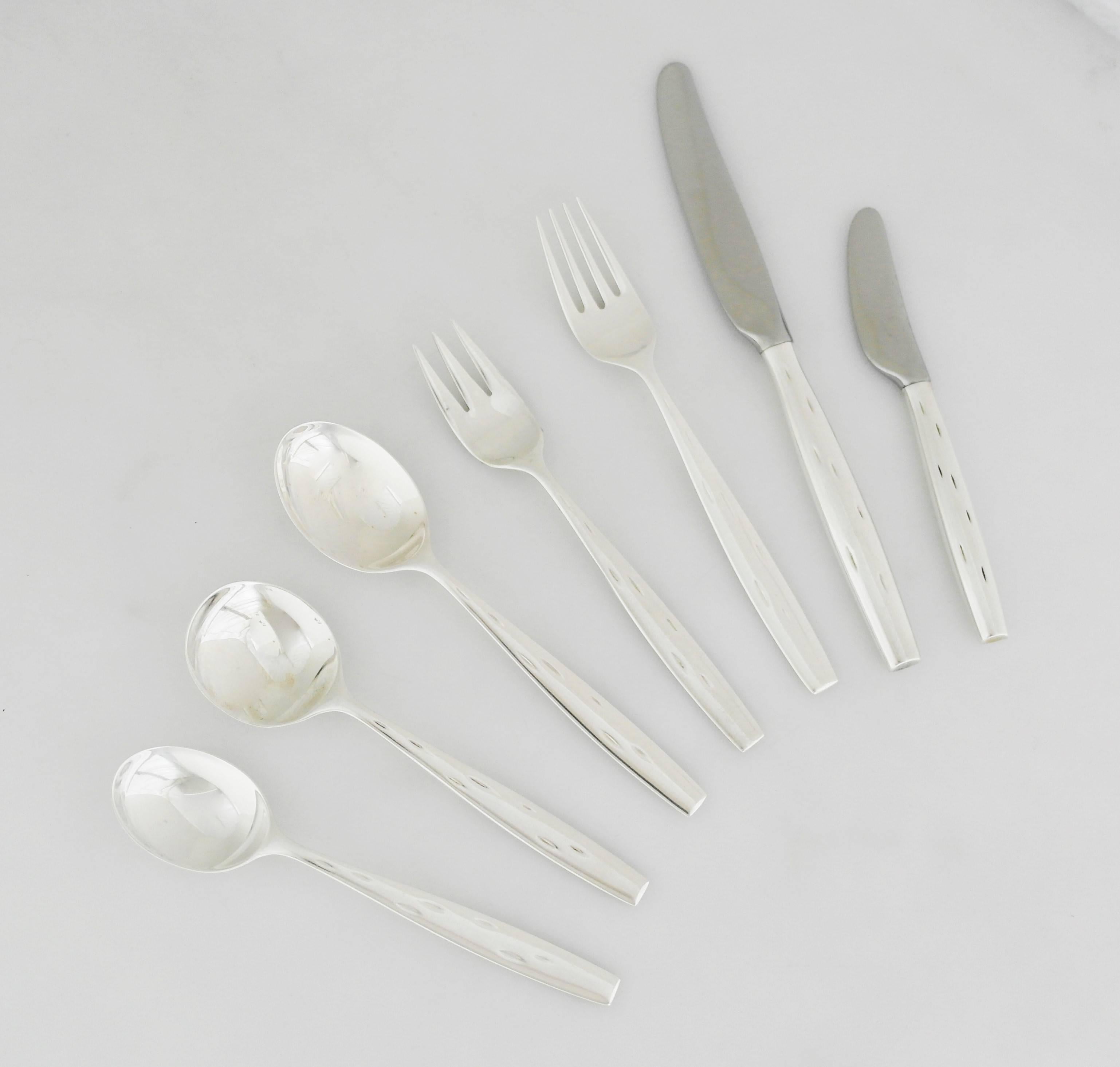 Being offered is a sterling silver flatware set by Wallace Silversmiths. In the scarce Discovery pattern introduced in 1957, designed by Raymond Loewy whom many consider the father of modern design; comprising a seven-piece place setting for 12
