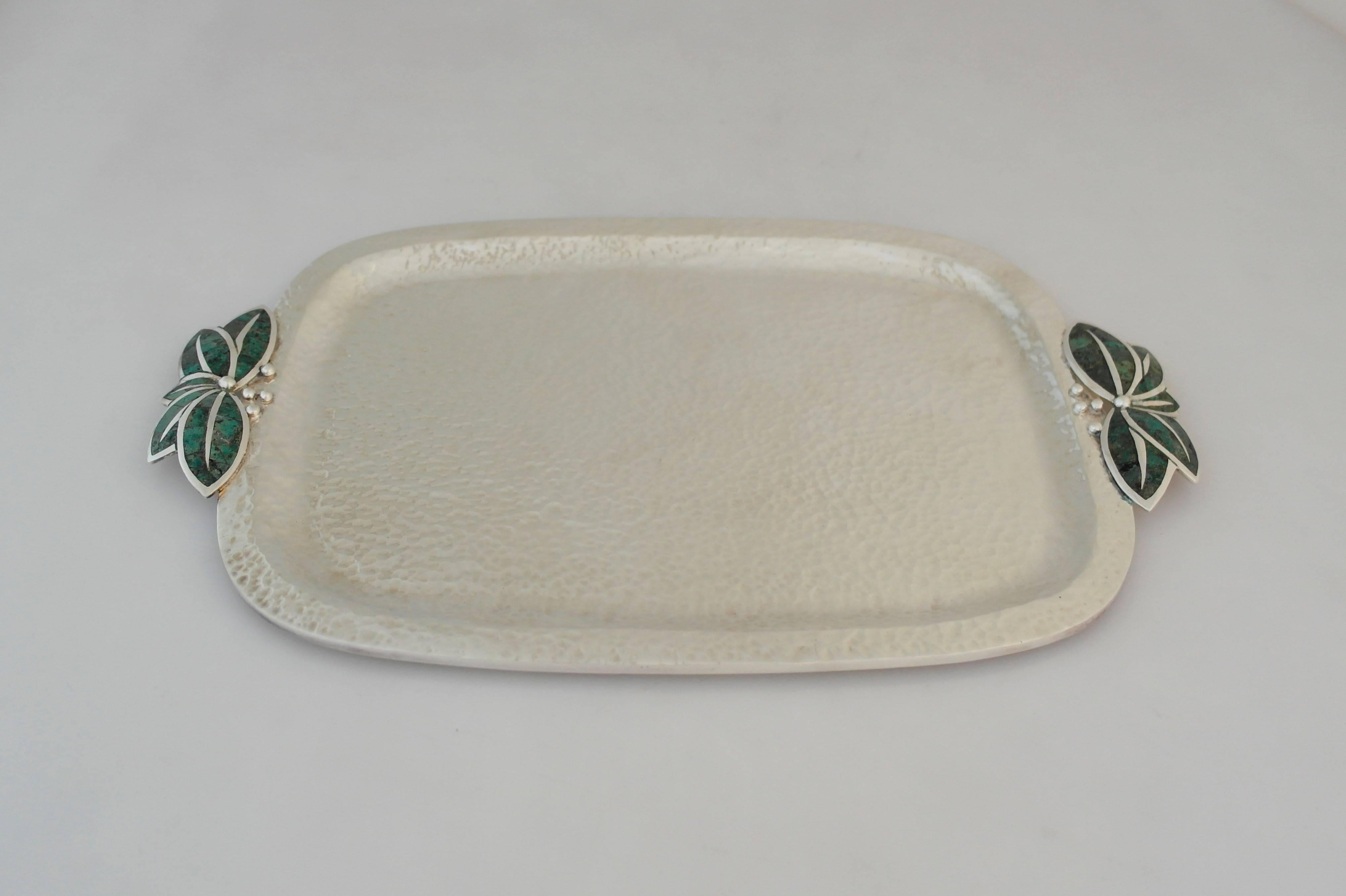 Being offered is a silver plate tray by Los Castillo of Taxco, Mexico. Rectangular tray decorated with butterfly handles and malachite inlay. Dimensions: 12