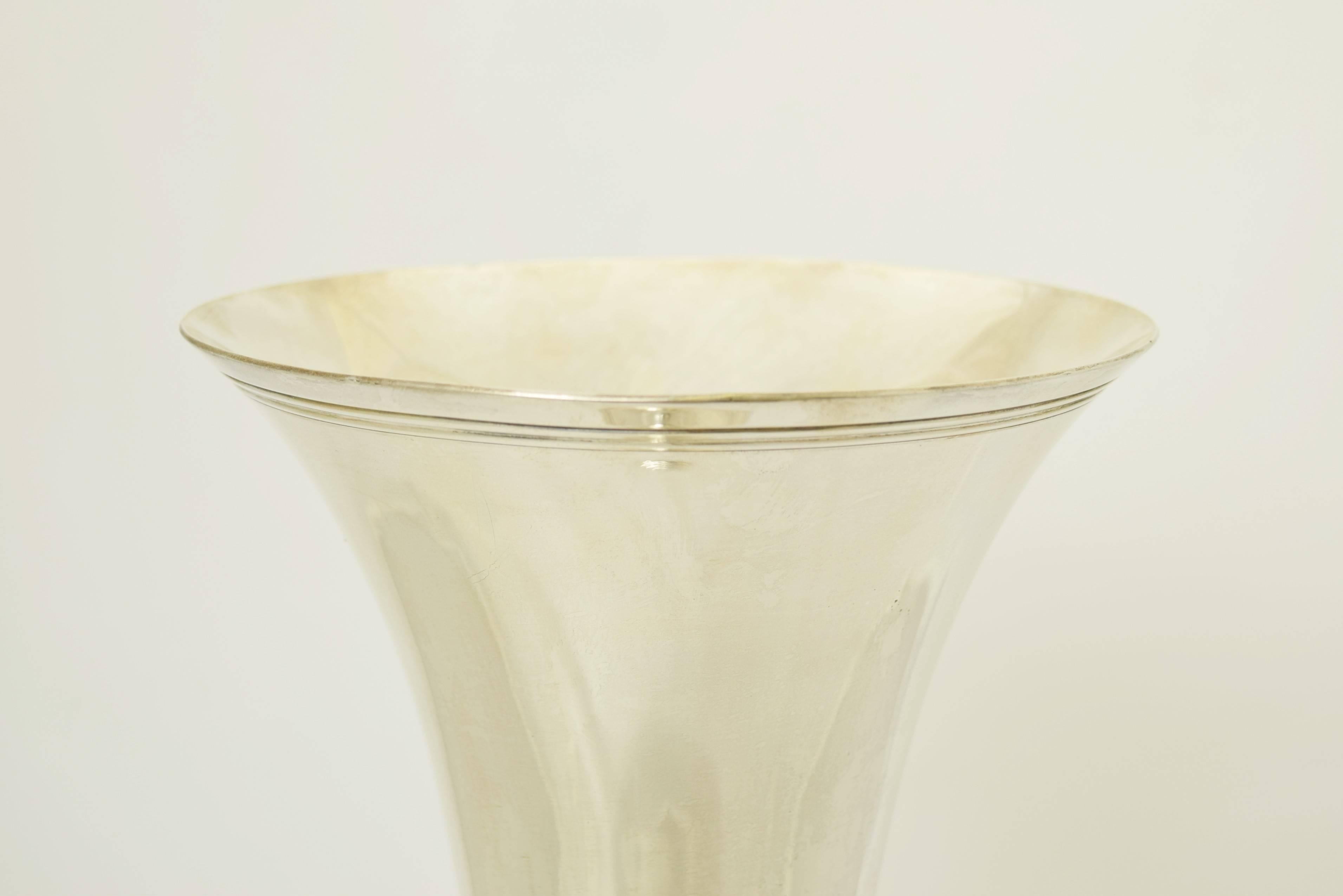 Being offered is a large sterling silver vase by Tiffany & Co. of New York. Of trumpet form with incised detail at the rim and base. Dimensions: 20 inches height. Marked as illustrated. In excellent condition.