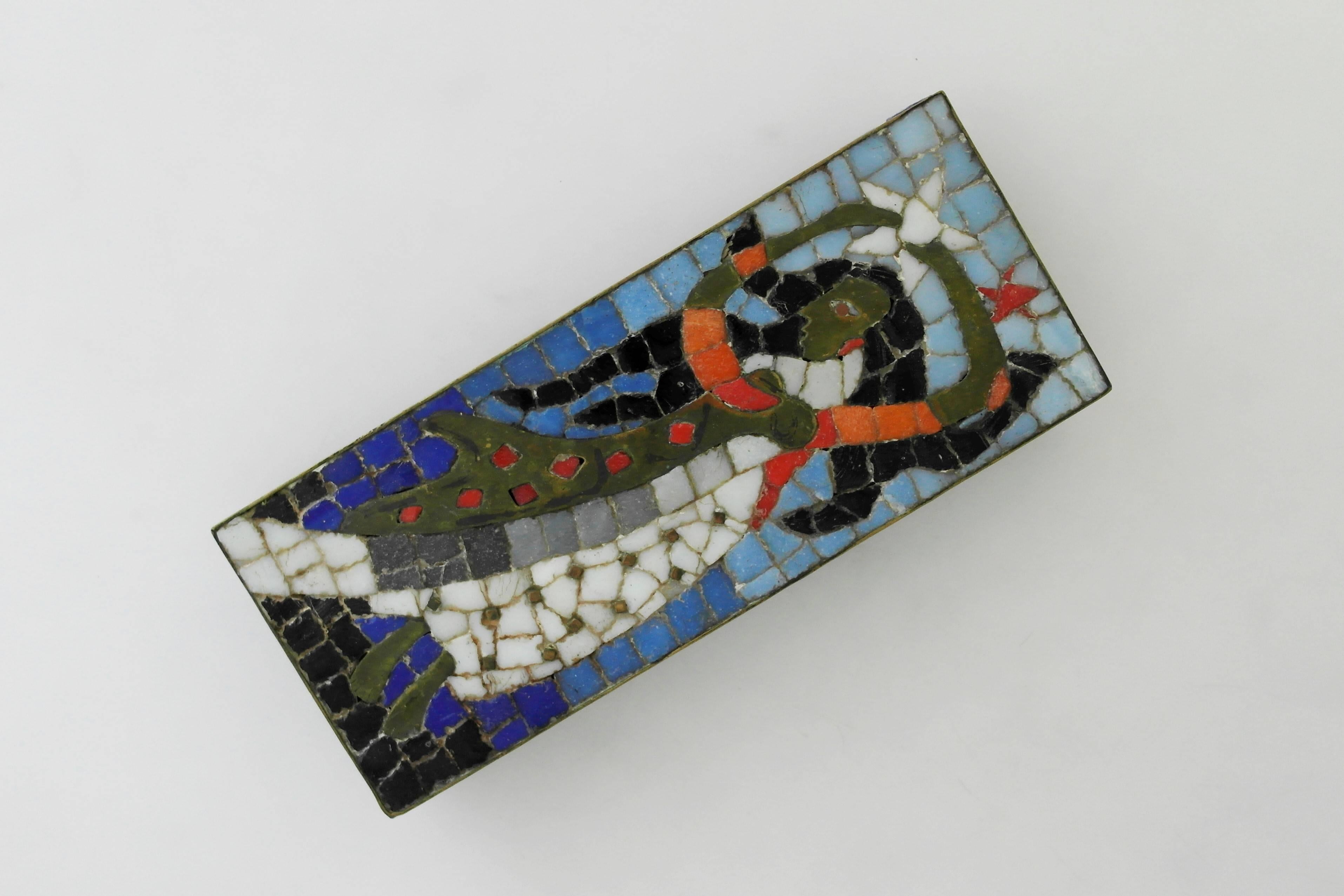 Being offered is a large brass and mosaic glass box by Salvador Teran of Taxco, Mexico. Hand-wrought rectangular box made of brass, with multicolored glass tiles forming a Pre-Columbian motif. Dimensions: 10 1/4 inches long x 4 1/4 inches wide x 1