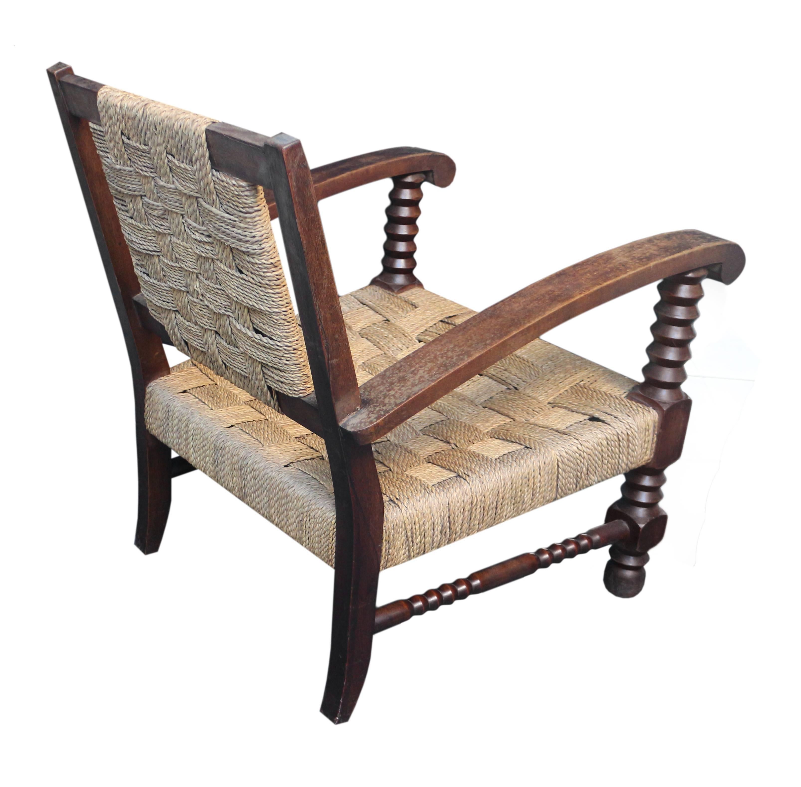 Set of three seagrass and wood lounge chairs.