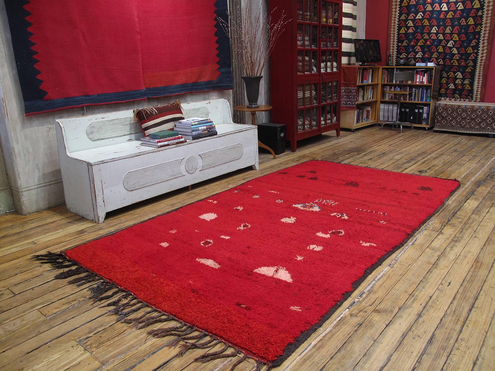 Rehamna Moroccan Berber rug. An old Moroccan rug from the region north of Marrakech, where the Berber aesthetic of the Atlas mountains meets the Arab culture of the coastal plains. Rug is an older example with intense red ground, decorated with