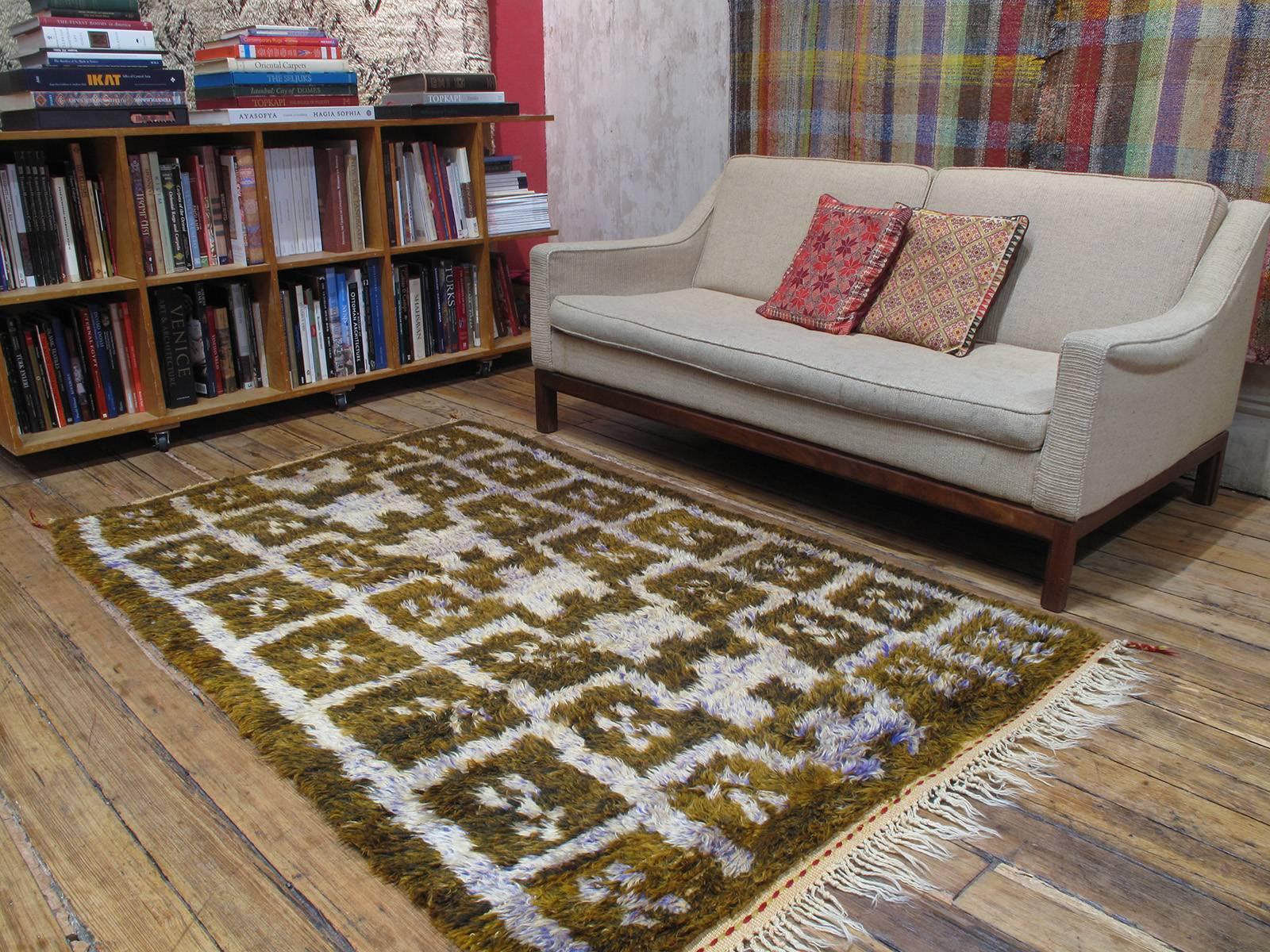 A beautiful village rug from Central Turkey, woven in the shaggy "Tulu" style, with silky, shiny Angora goat hair (mohair), featuring a whimsical interpretation of the well-known ascending arches design. The rug is very well preserved with