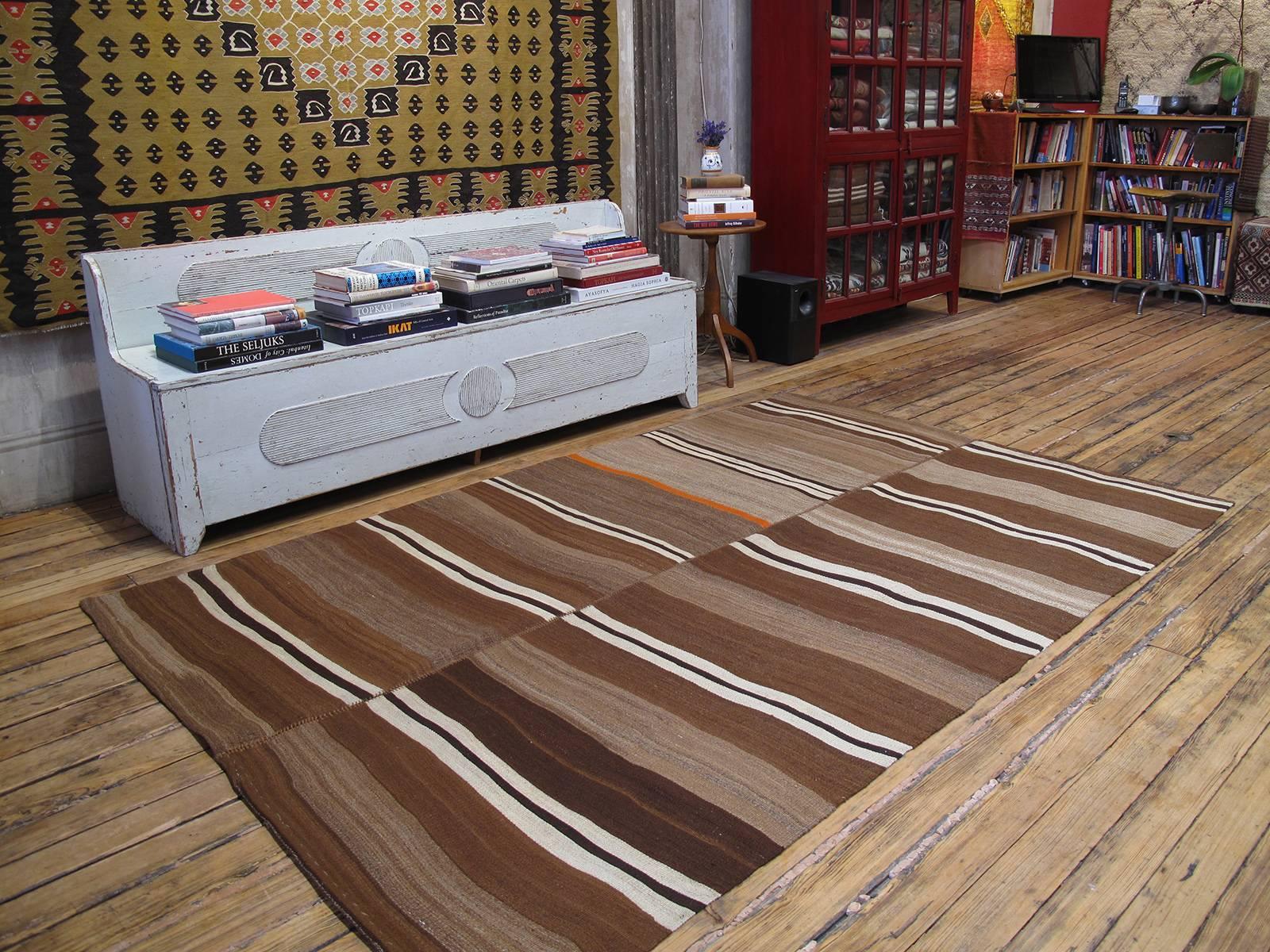 Urfa Kilim rug. A lovely old flat-weave rug from Southeastern Turkey, woven as a pair of runners on a narrow loom - they can easily be separated and used as runners. Groups of stripes on a background of natural brown wool with rich tonal variations.