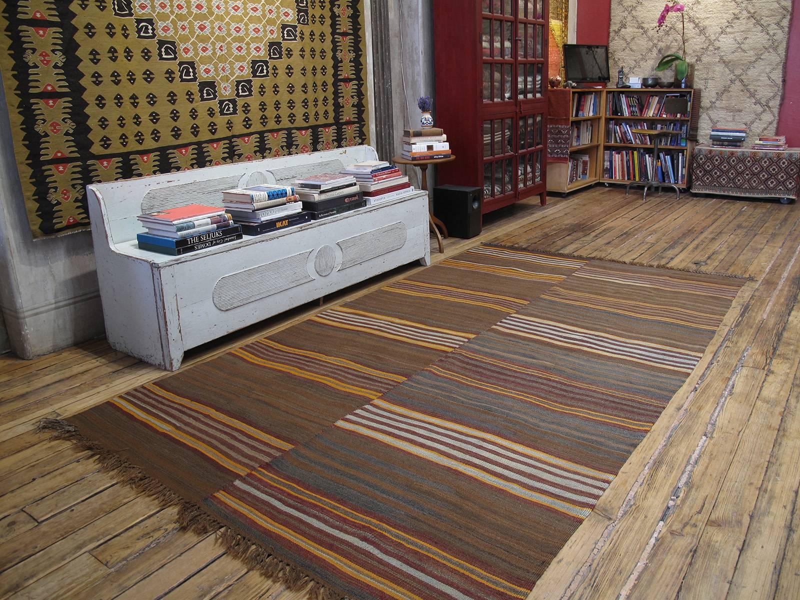 Urfa Kilim rug. A very nice old flat-weave rug from Southeastern Turkey, woven as a pair of runners on a narrow loom - they can easily be separated and used as runners. Groups of stripes on a background of natural brown wool with rich tonal