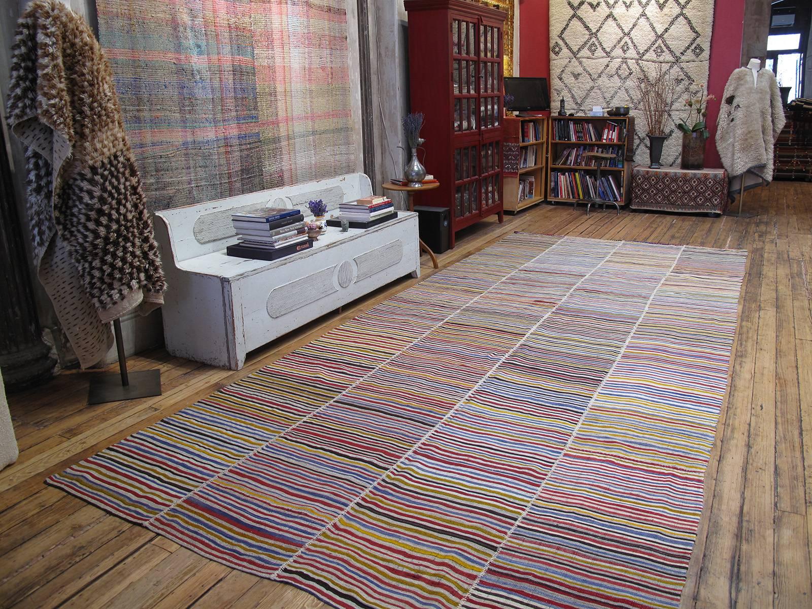 An old tribal flat-weave from Northern Iran, woven in four narrow panels and used as a simple, utilitarian floor cover in the weaver's household. Despite its humble origins, it has tremendous modern or Minimalist appeal and great authentic charm