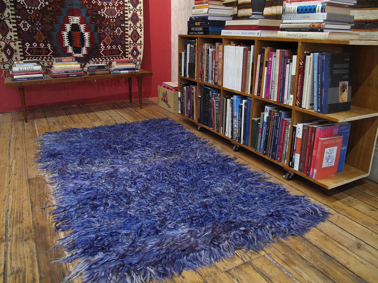 A lovely old shaggy rug from West-Central Turkey, knotted with long and loose strands of Angora goat hair (mohair), dip-dyed in violet-blue that has weathered very nicely with age. Such rugs were used to provide warmth and comfort in the weaver's