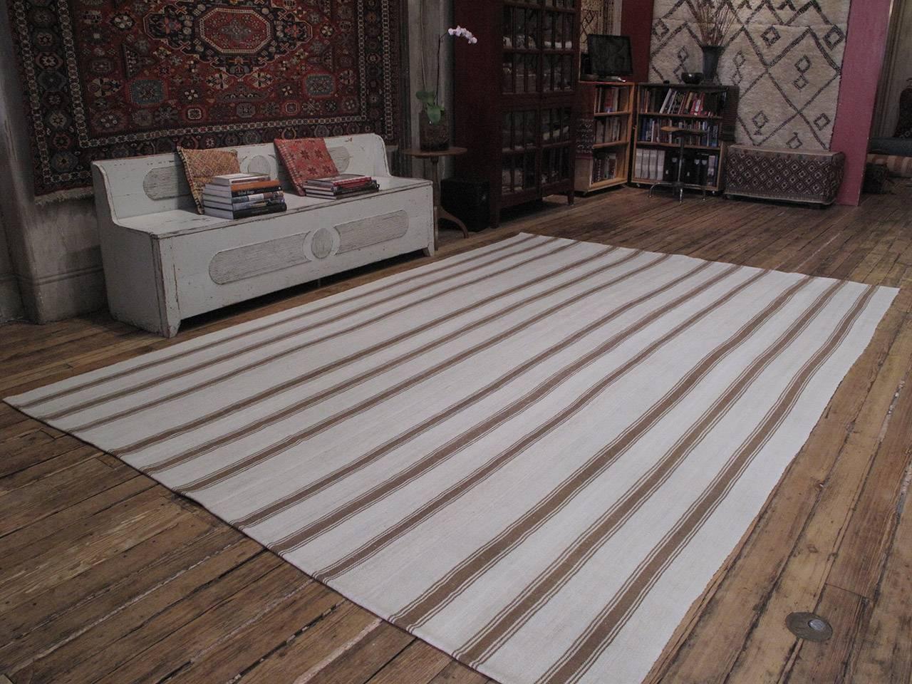 An old tribal flat-weave of large proportions from Central Turkey, woven entirely with wool in natural tones of ivory and brown in alternating bands. The wool quality is superb and the weave is very tight and heavy, creating a very sturdy floor
