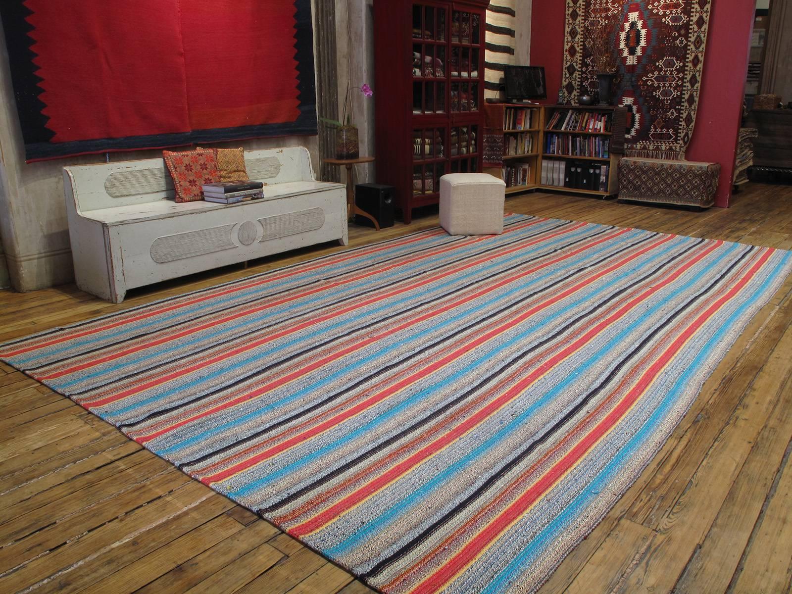 Large Kilim rug with colorful stripes. An unusually large and colorful flat-weave from Central Turkey, rug is woven with an ingenious mixture of cotton rag and wool.

(Rug size can be adjusted. Please inquire.)