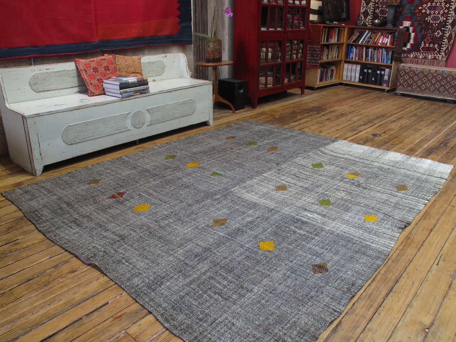 A beautiful old tribal floor cover from Southeastern Turkey, woven with goat hair and wool in natural tones and decorated with rows of 