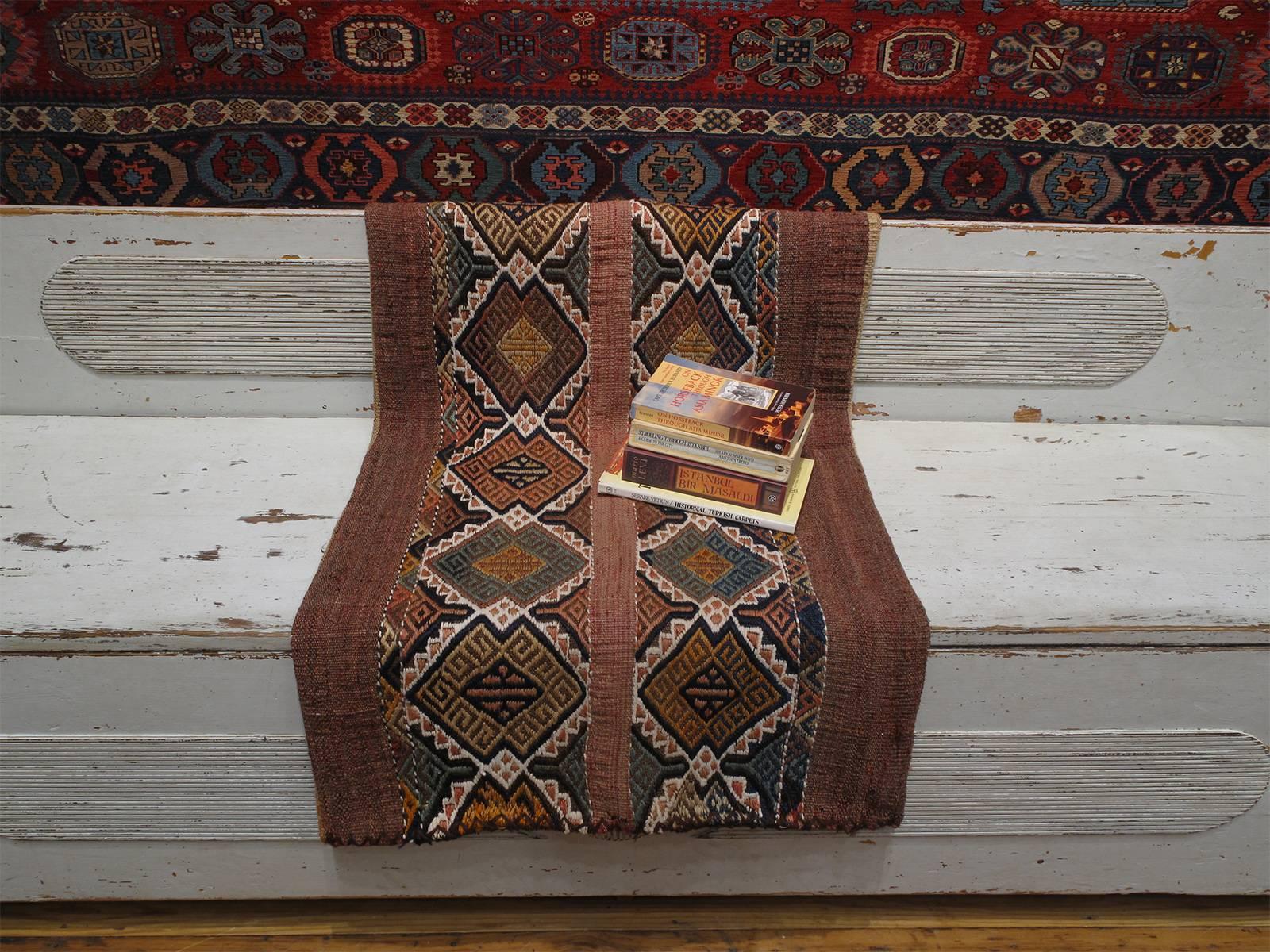 A tribal cargo bag from Southeast Turkey, flat-woven with an intricate brocaded panel in the front. Woven exclusively for domestic use, with very little change over generations, these sacks were probably the best preservers of centuries-old