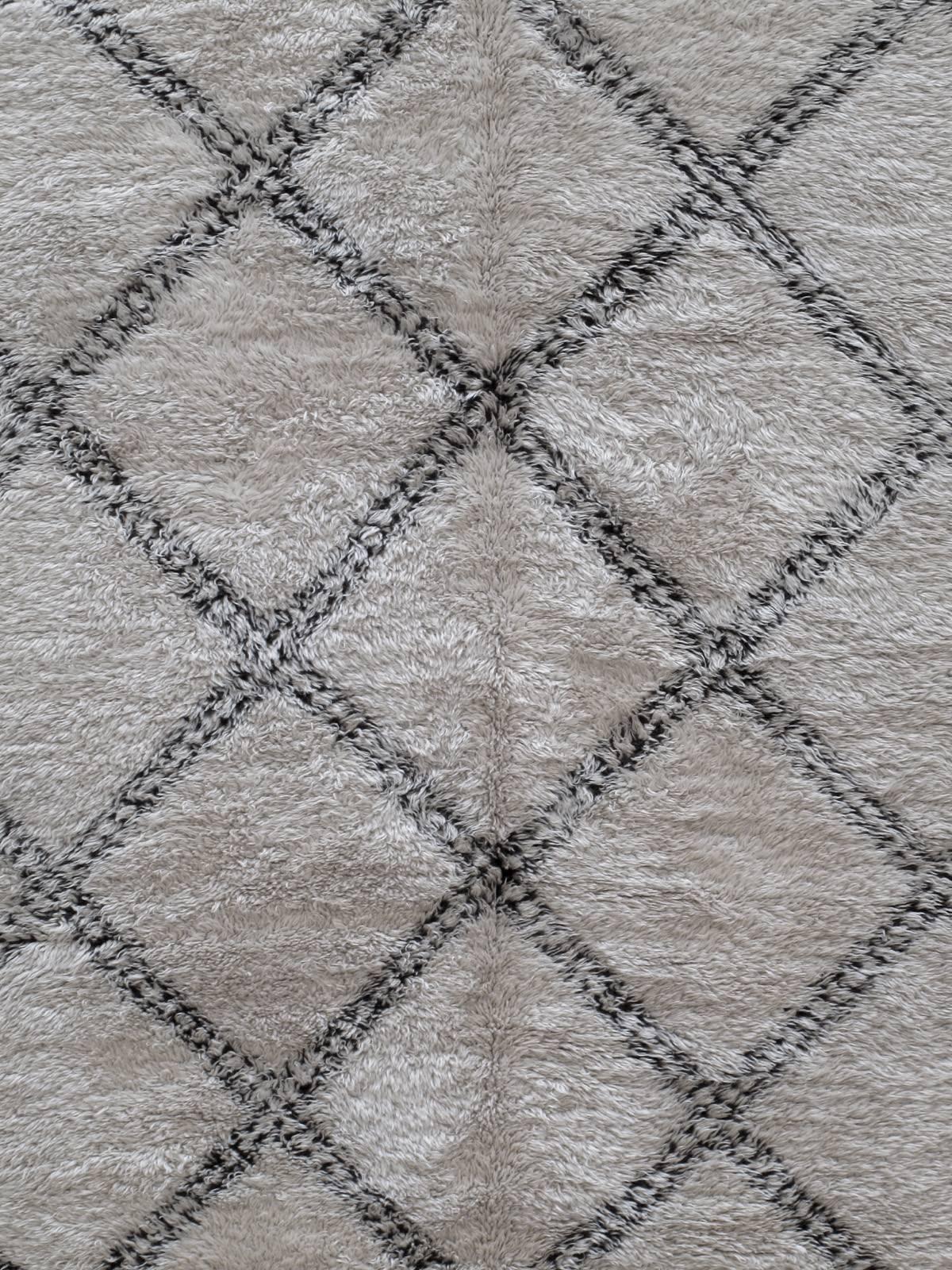 A large Moroccan Berber carpet from the Middle Atlas Mountains, woven by the Marmoucha tribe. This is a particularly nice example with excellent wool, tight weave and great patina. The color is quite light and the texture is finer than usual. Often