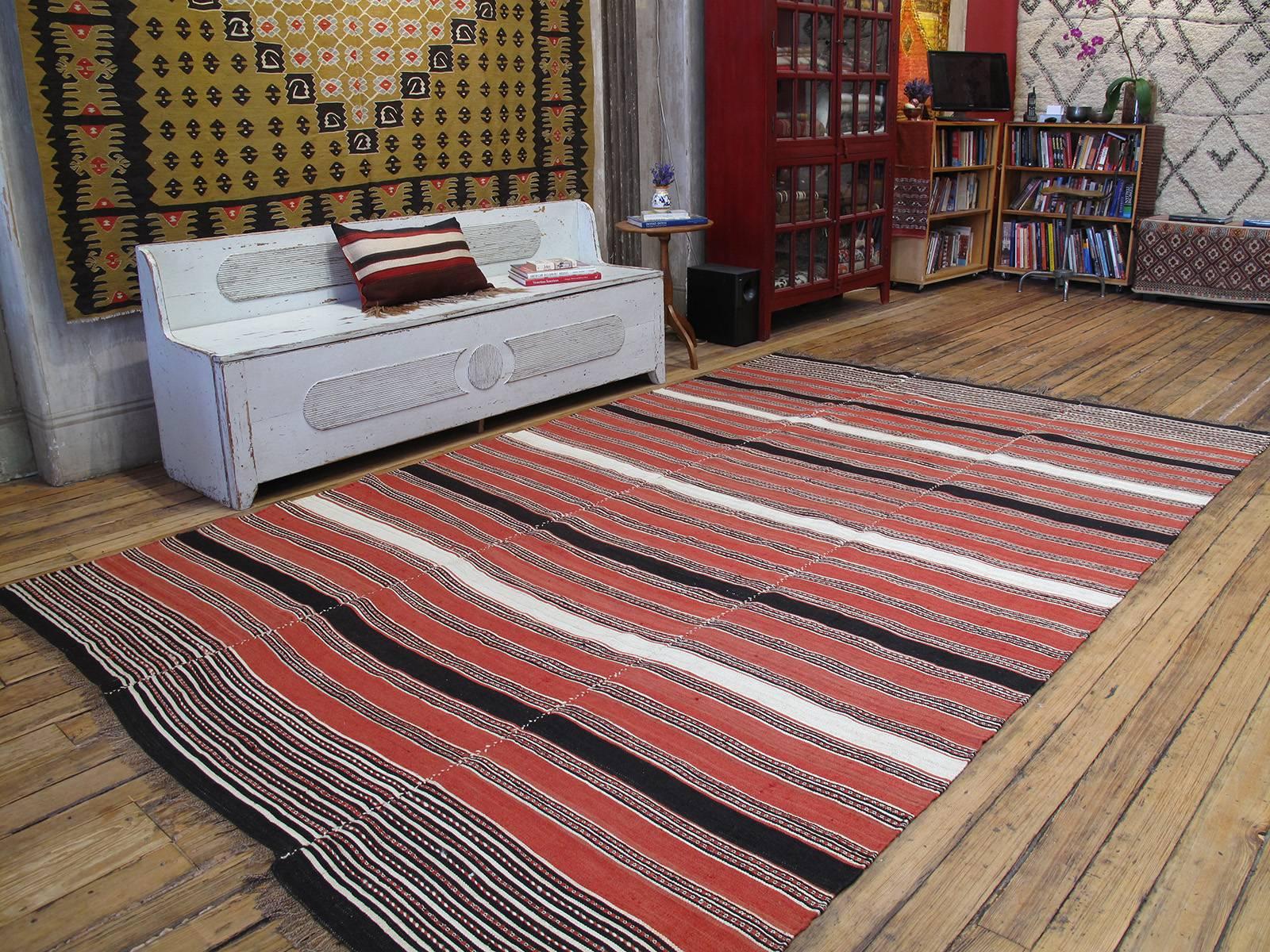 Banded Kilim rug. A handsome old tribal flat-weave rug from Northern Iran, woven in three panels with matching bands in red, brown and ivory. A simple and traditional floor cover or rug with great modern/Minimalist appeal. Rug has generous