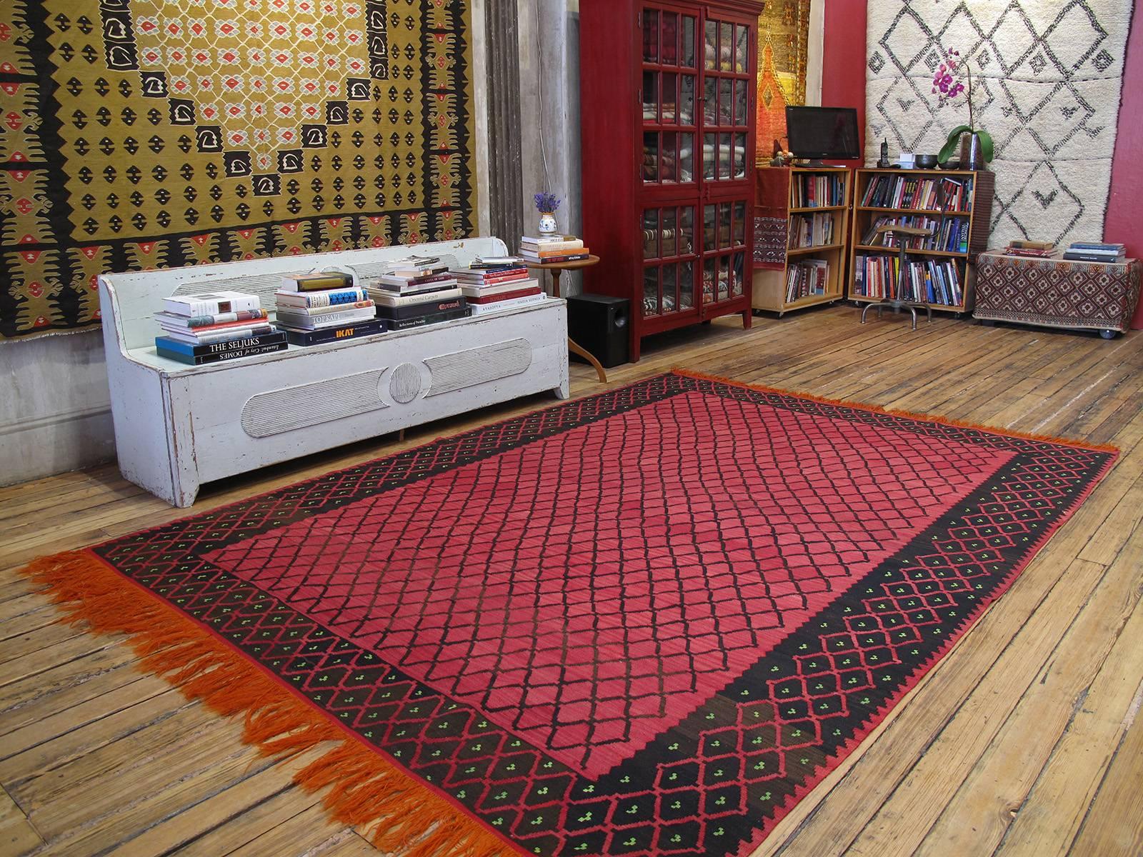 Balkan Kilim rug with lattice design. A lovely old flat-weave rug from Southeastern Europe with a simple, almost minimalist design and color palette. The kilim rug does have some age but was probably used very sparingly as it has survived in almost
