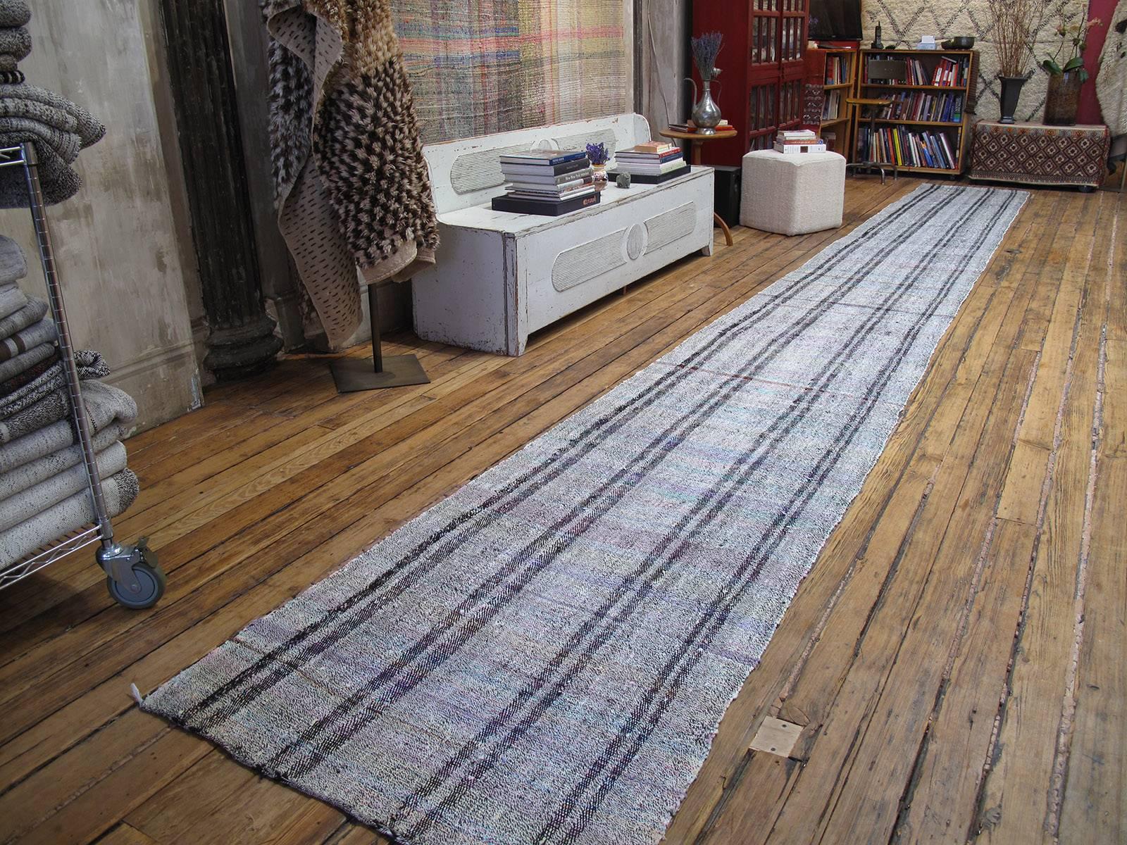 Long and narrow Kilim runner rug. An old flat-woven tribal runner of very long and skinny proportions, made with an ingenious mixture of goat hair, cotton and a little bit of colorful rag. (Size can be adjusted.)