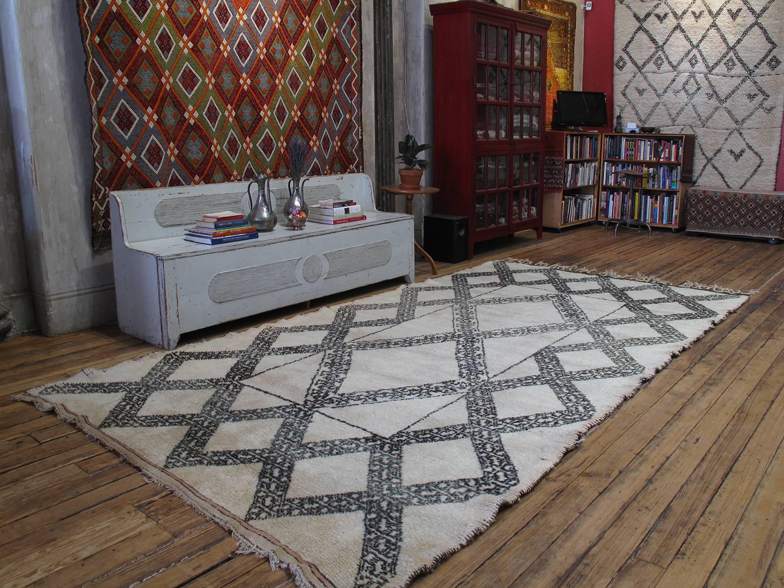 A great old Moroccan Berber rug from the Middle Atlas Mountains, featuring a very unusual design, a unique and refined interpretation of the Classic diamond grid. Though it resembles the work of the famed Beni Ouarain, it was probably woven by the