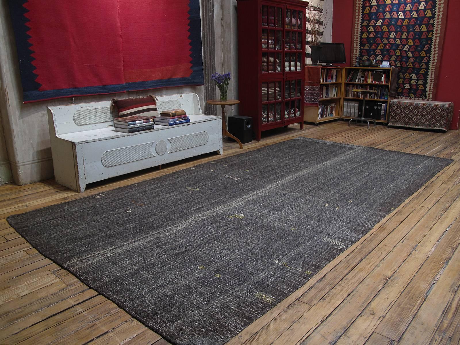 A simple, Primitive tribal flat-weave from Southeastern Turkey, woven in two panels on a narrow loom, using a mixture of goat hair and wool in natural dark brown-gray tones. Surprisingly chic, with great modern/Minimalist appeal, despite its humble