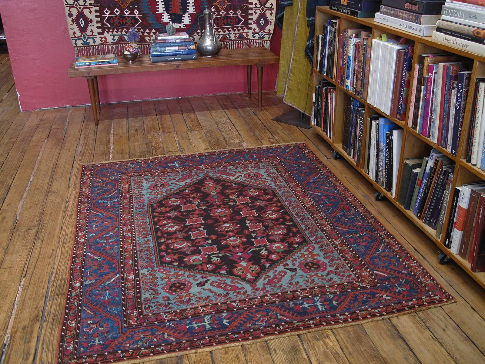 With its distinct border featuring tulips and carnations and other stylized floral forms everywhere, this antique rug from Kula, a venerable weaving center in Western Turkey for centuries, is a direct descendant of Ottoman Turkish weavings from the