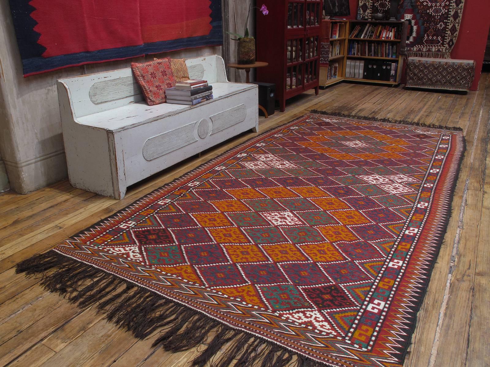 Afghan Tribal Kilim rug. An impressive tribal flat-weave rug from Northwestern Afghanistan, in characteristic wide and long format, featuring a design of concentric diamonds. The color palette is quite vibrant as the Kilims appears to have seen very