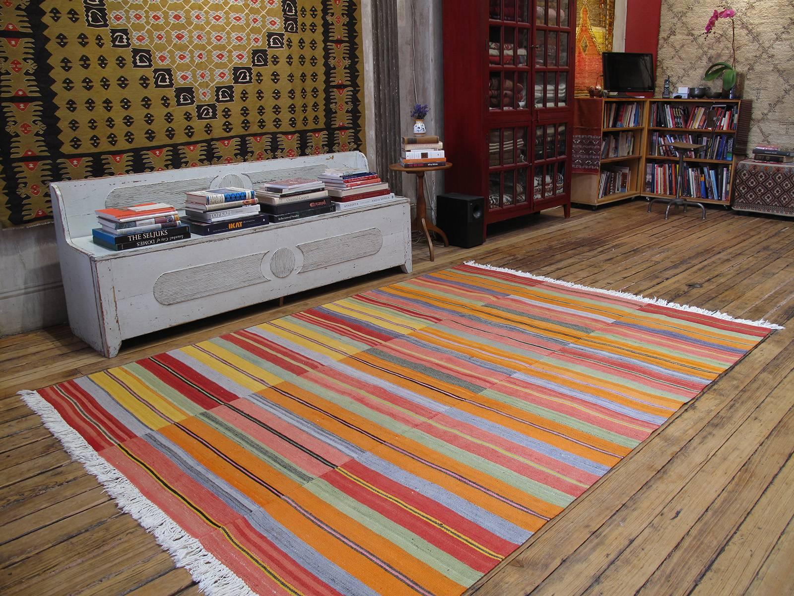 A lovely Turkish kilim, woven in three narrow panels, with a cheerful palette of colors