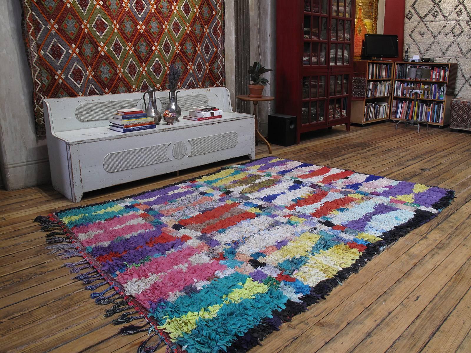 A Moroccan rug, woven entirely with cut-up pieces of fabric from old clothes, etc. - boucherouite means rag or torn cloth in Moroccan Arabic. This is a great example of this type in unusually large format.

A relatively recent phenomenon, such