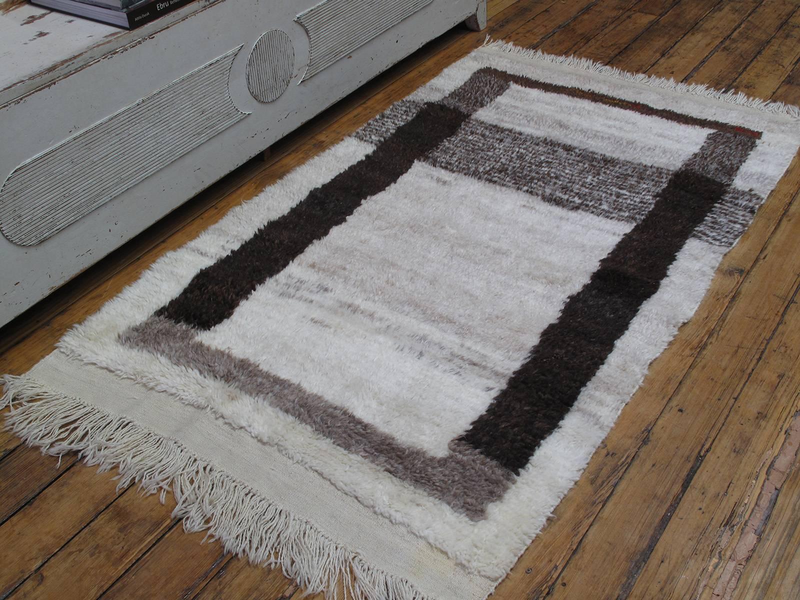 A small shaggy village rug from Central Turkey, woven with hand-spun wool in natural ivory and browns, creating a unique graphic image.