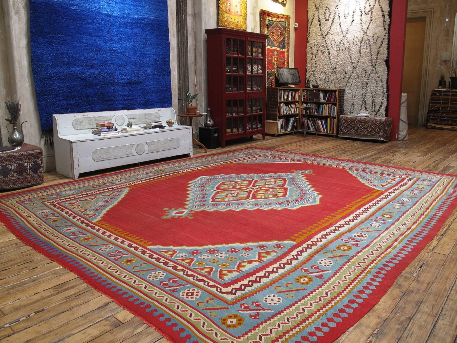 Large antique Oushak Kilim rug. A large format antique kilim rug, woven in the Oushak region of Western Turkey, displaying the classic central medallion design and color palette. Such kilims were contemporary with the many antique Oushak carpets