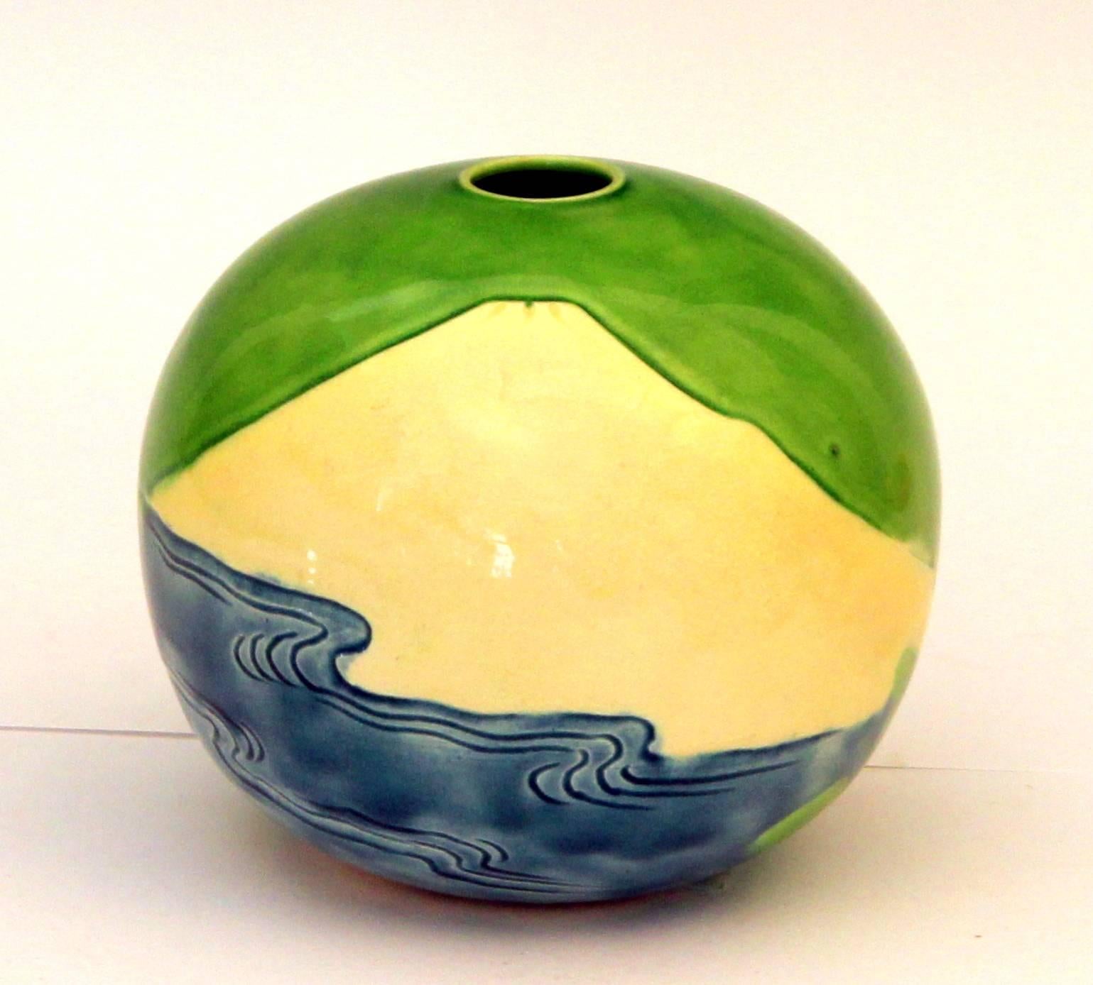 Spherical vase with incised image of a mountain above the ocean against a vibrant lime green sky. Impressed Kiln mark. 5