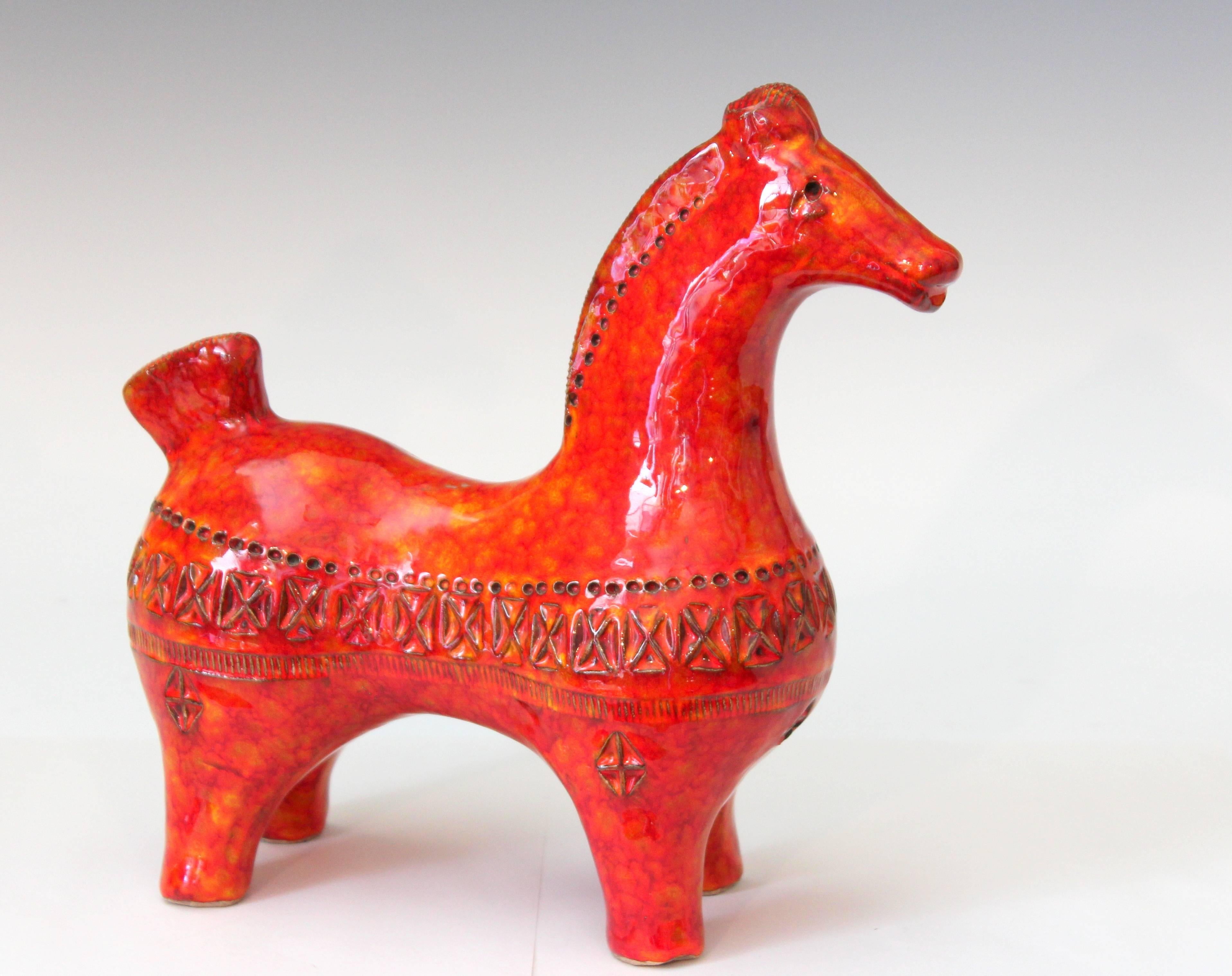 Great Bitossi horse standing gracefully tall and taught with energy. Crisply impressed Rimini decor and finished with electrifying atomic orange red mottled glaze, circa 1960s. Measures: 9 3/4