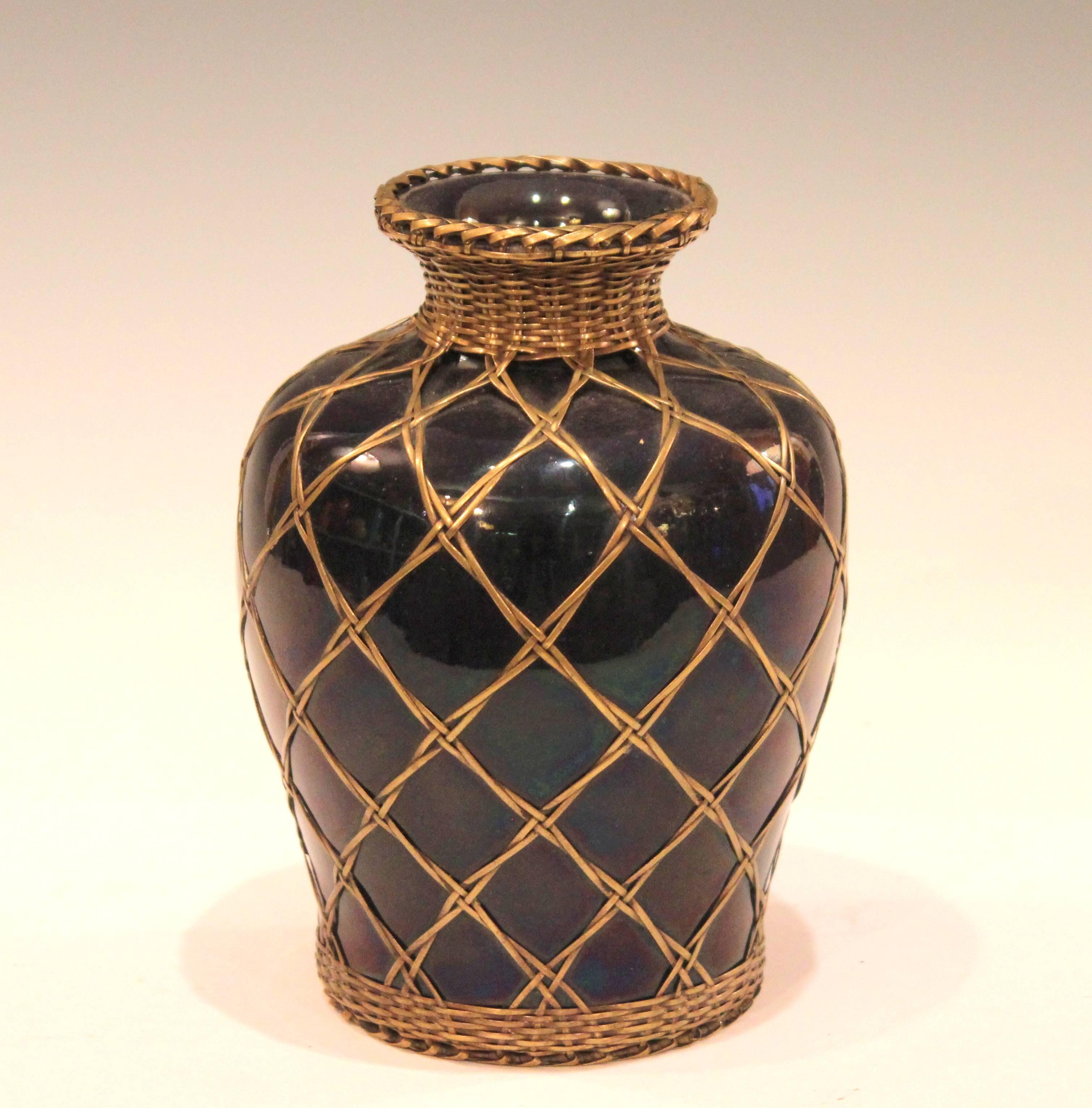 Antique Awaji pottery vase from the Sumoto kiln of Tamura Kyuhei, circa 1910. With tightly wound bronze weaving over a dark aubergine glaze. Measures: 7
