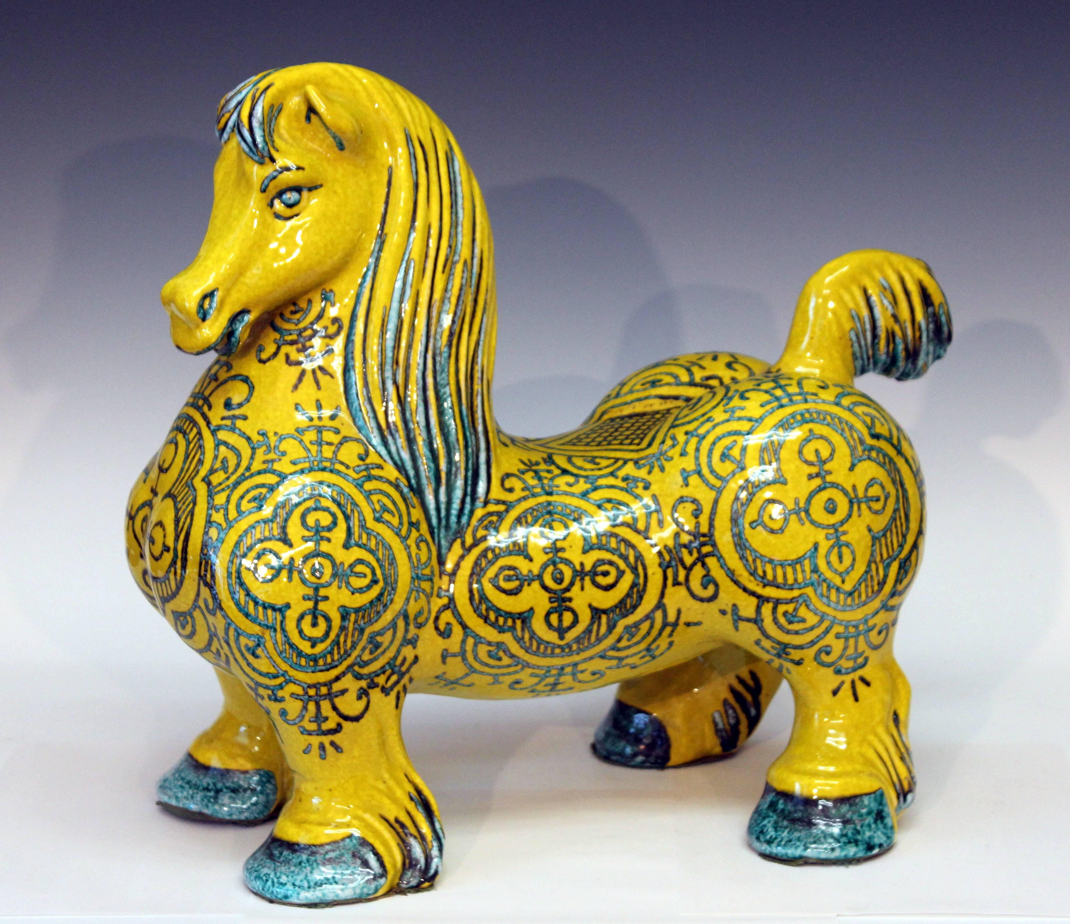 Large and heavy Italian pottery horse by the Mancioli Pottery, circa 1960s. The muscular figure standing proud with elaborate design painted in a curious fugitive green glaze over bright yellow. This is the largest of three sizes that were produced