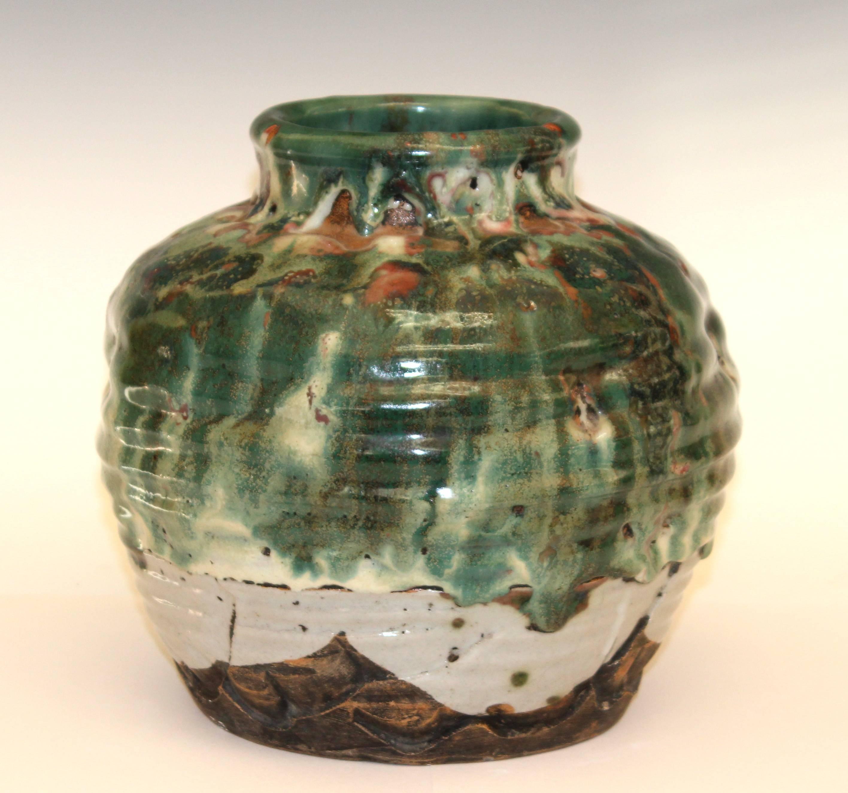 Large Awaji stoneware vase, gouged and dented, with heavy multi colored drip glaze, circa 1930. Impressed marks. 8 1/2