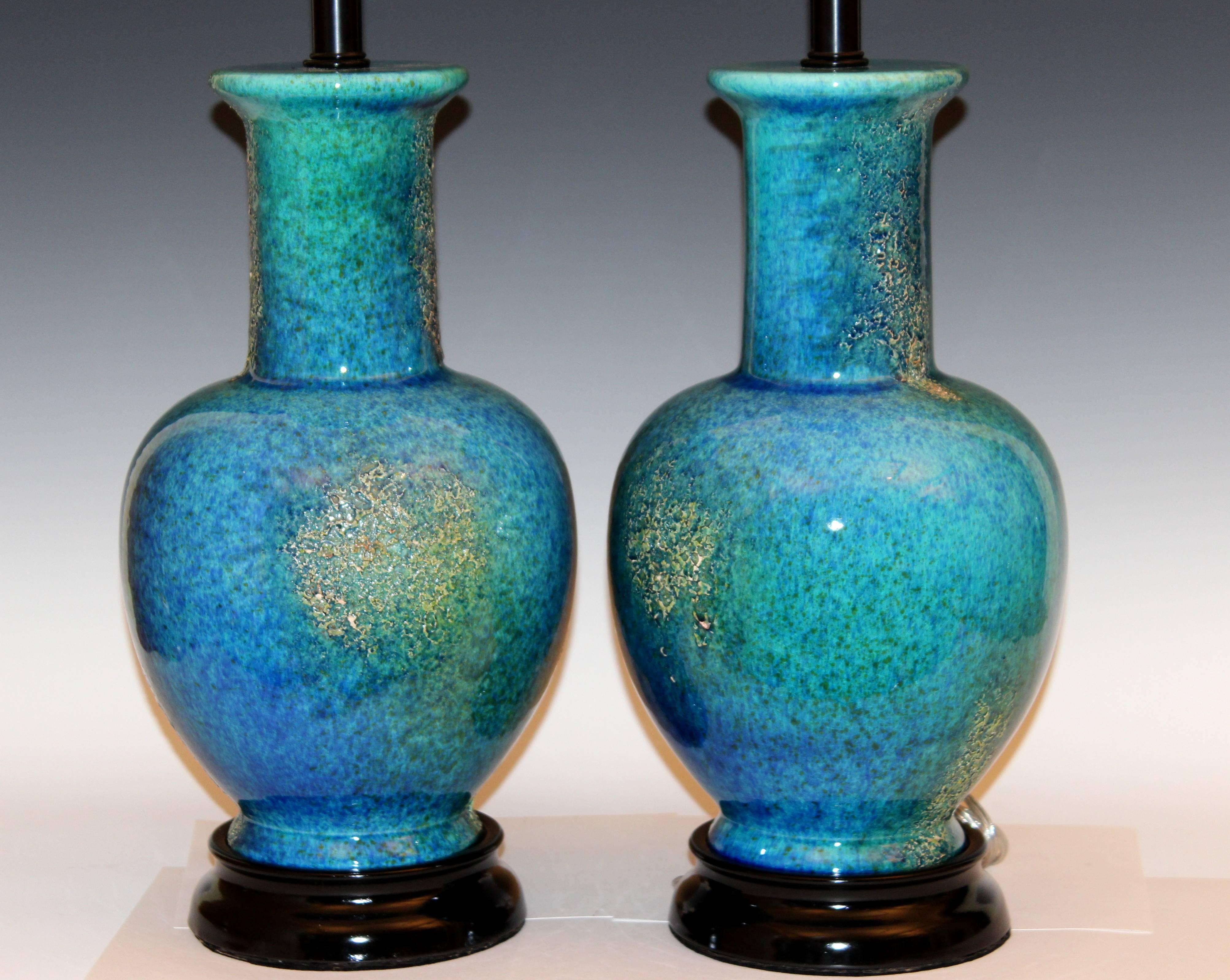 Large pair of vintage Haeger pottery lamps in mottled turquoise lava glaze designed by Helmut Bruchman, circa 1960's. New wiring and sockets with 3-way switches, reconditioned hardware. 31