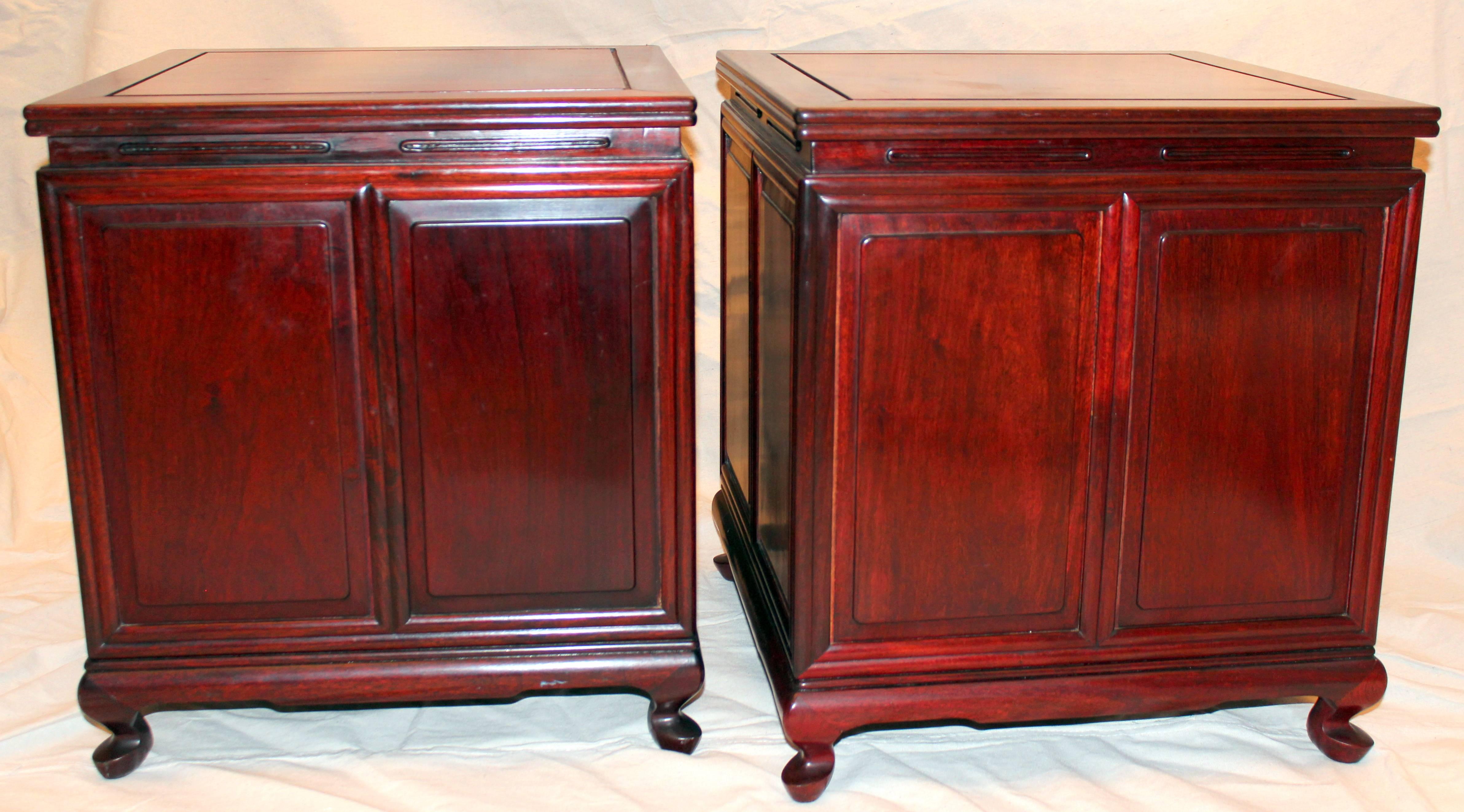 Beautifully made pair of vintage Chinese rosewood side tables, circa 1970s. Each with four storage drawers concealed behind a vertical tambor door. With traditional Chinese construction and Western style Queen Ann feet was probably made for export