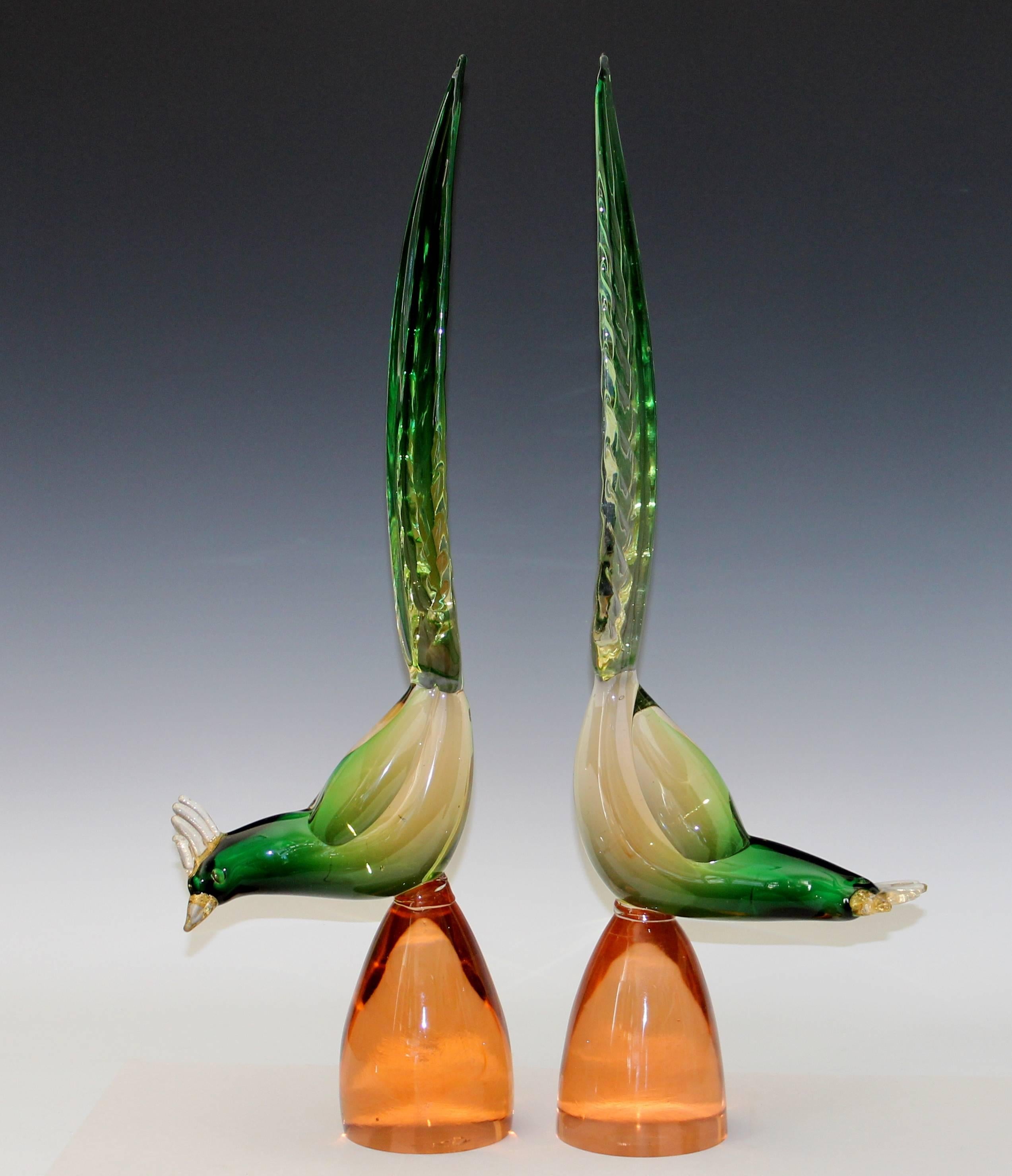 True pair of large Murano glass pheasants, circa 1970s. The birds are green and clear glass shot with gold flecks in the tails and combes. 26