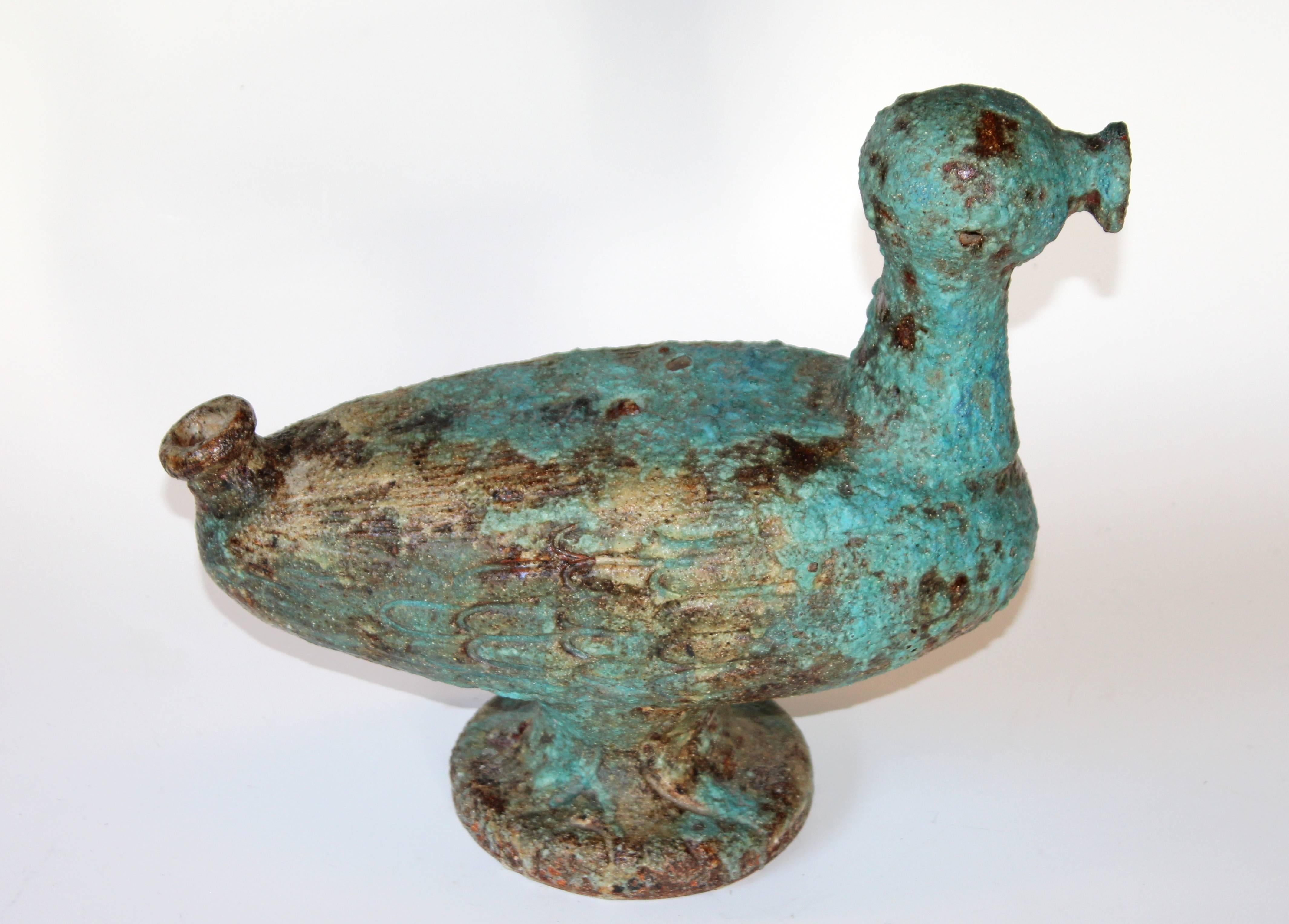 Large vintage pottery abstracted duck figure with tactile blue lava scavo glaze, circa 1950s. With spigot spout nose and tail and whimsical incised feet on each side of the base. Designed to be made into a lamp with no evidence that it ever was.