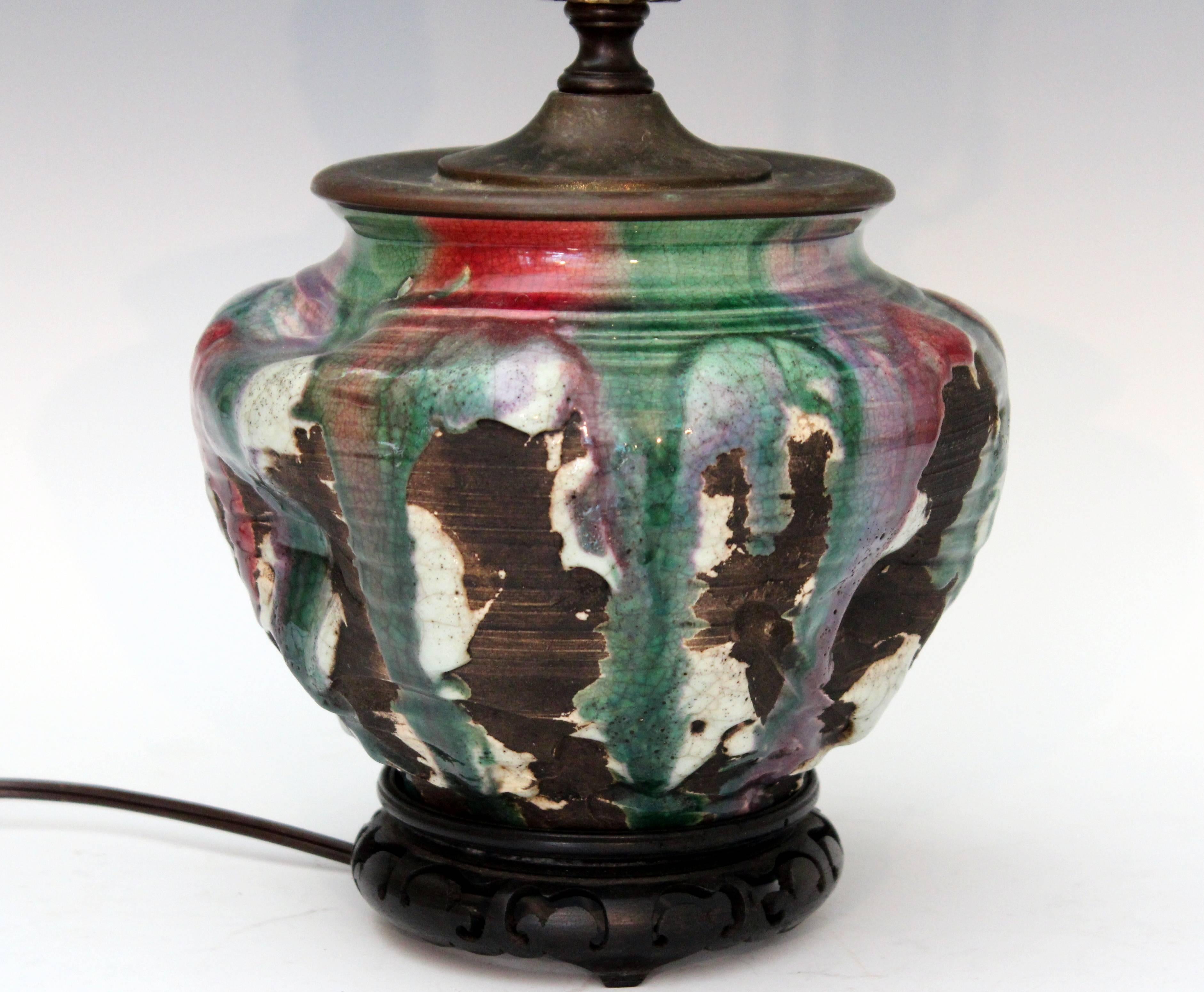 Heavy Awaji stonewarelamp with defined ribs, pinched and gouged surface and flowing with heavy multicolored flambe drip glaze, circa 1930. Impressed marks. Pottery measures 6
