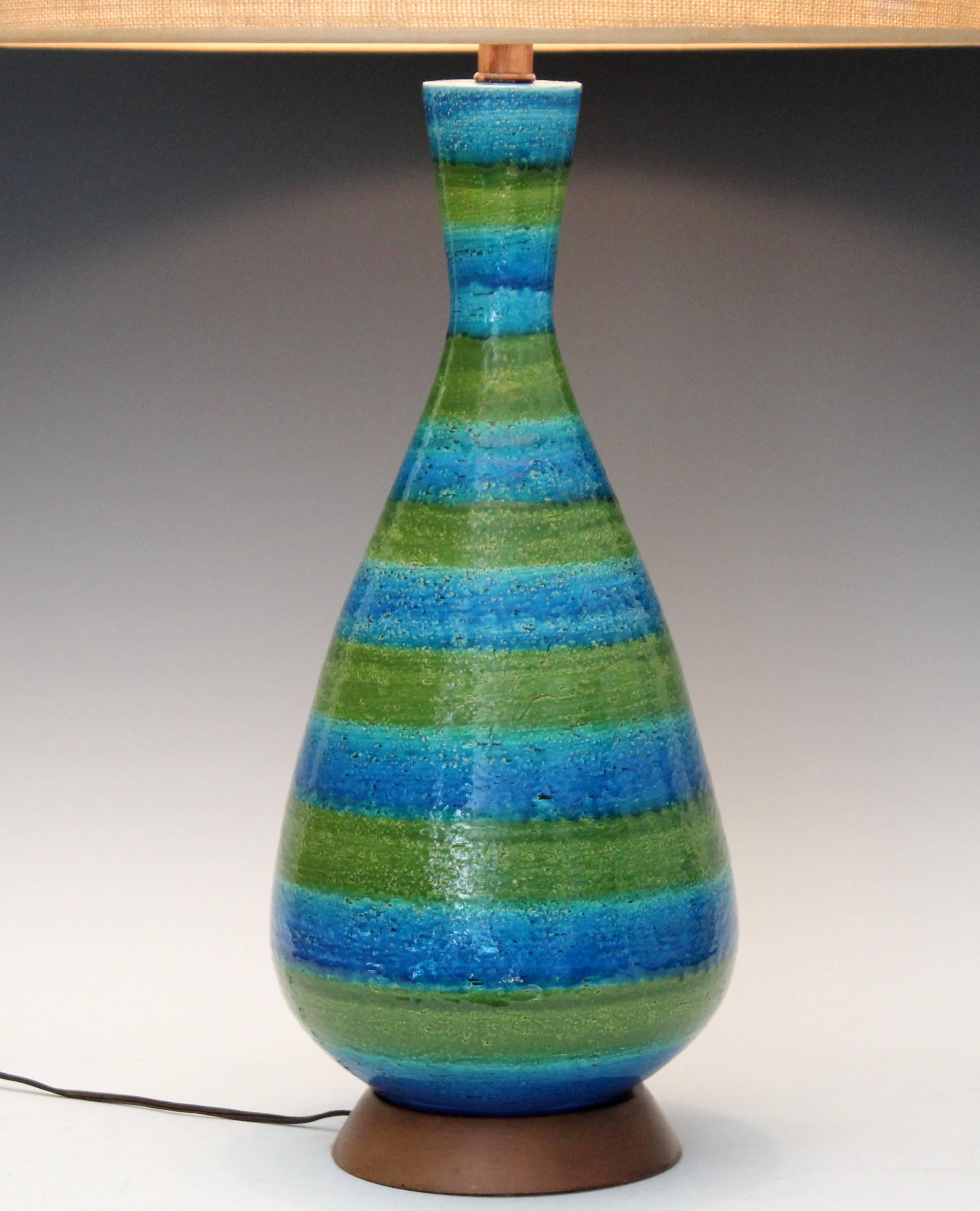 Large hand-turned Bitossi bottle form lamp with alternating bands of green and blue glaze, circa 1960s. Three-way switch. 35" high overall, 20 1/4" to top of pottery, 9" diameter. Shade not included, please inquire for