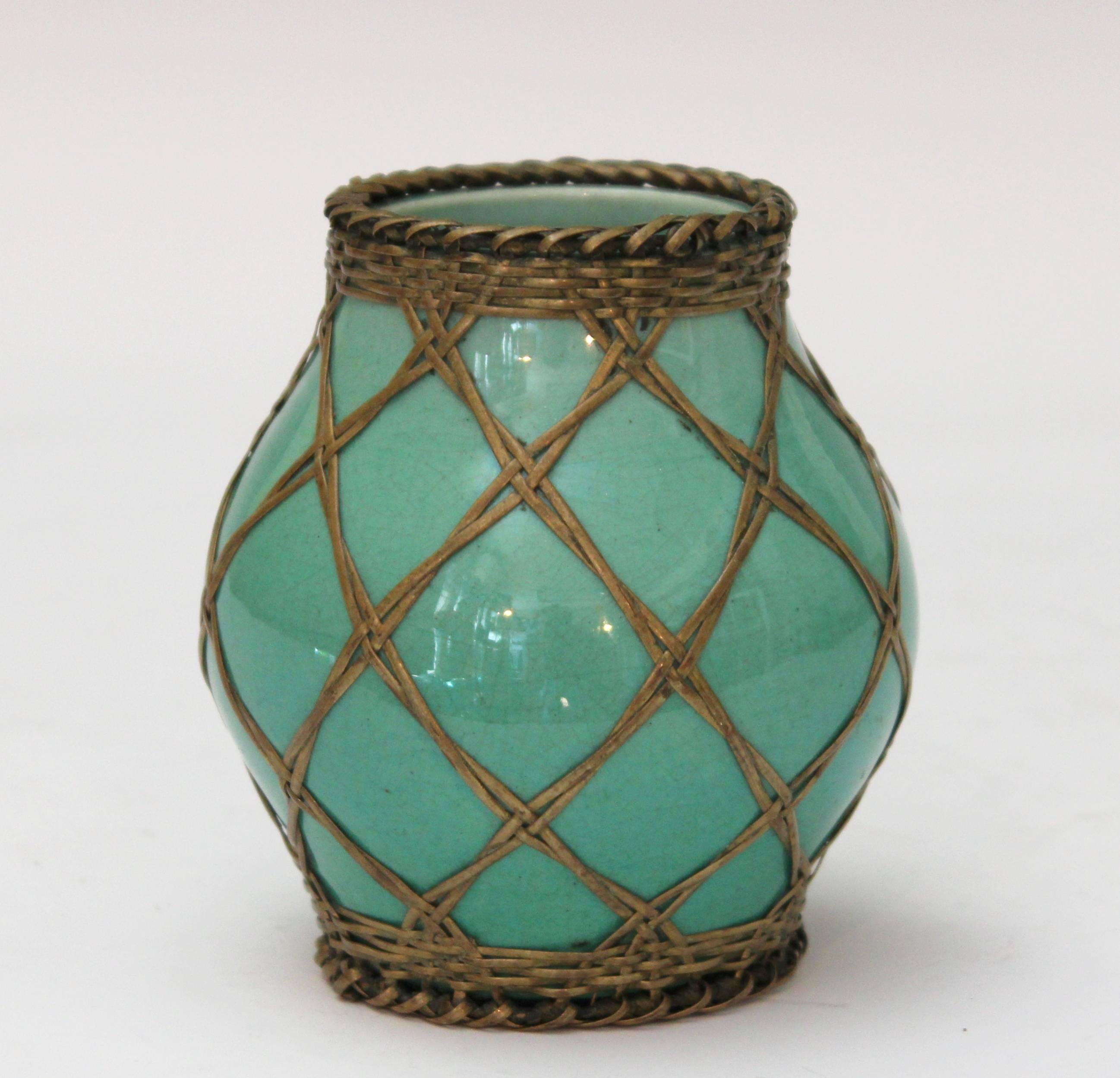 Awaji Pottery jar in simple, organic form with light green monochrome crackle glaze and wrapped with bronze wire in decorative pattern, circa 1910. Impressed export and studio mark of Tamura Kyuhei. Measures: 4